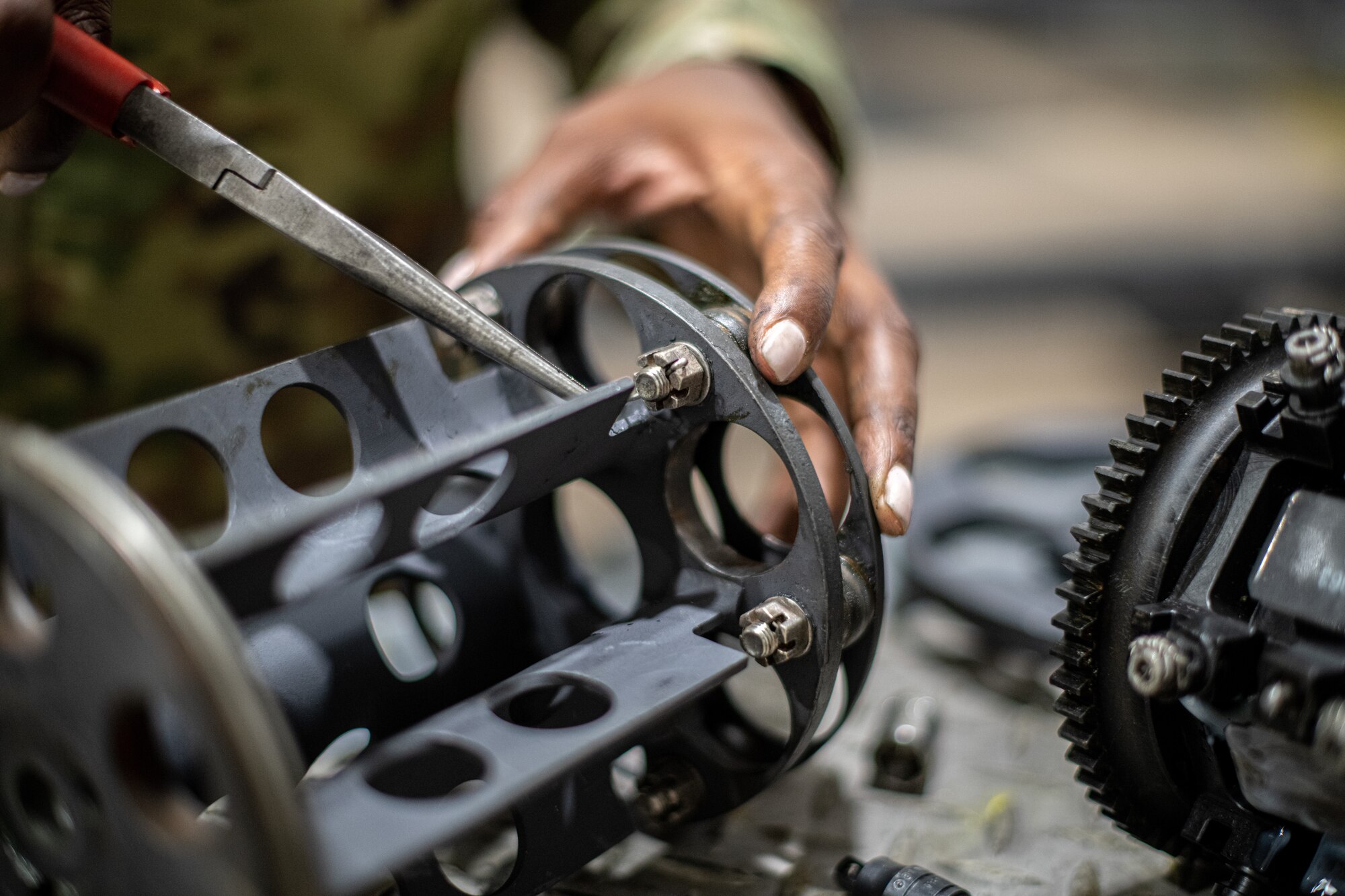 Airmen works on weapon part