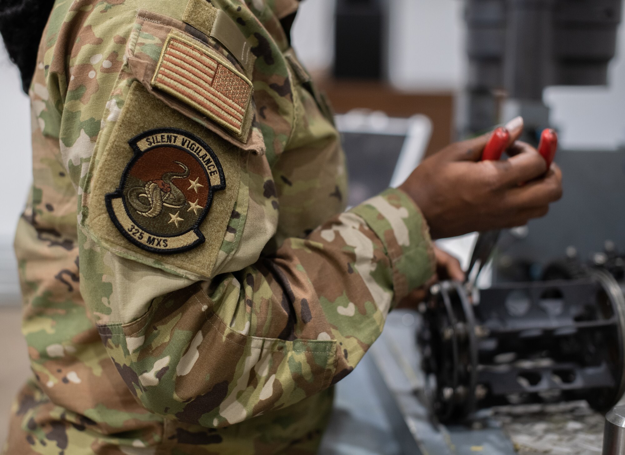 Airmen works on weapon part