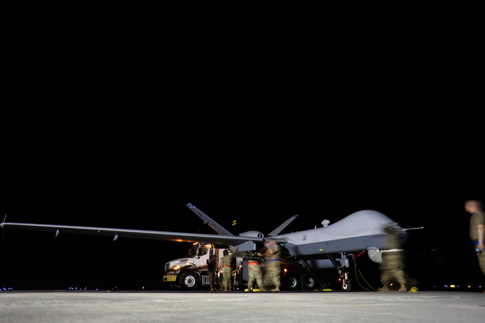 U.S. Air Force maintenance Airmen from the 163d Attack Wing and 49th Aircraft Maintenance Squadron refuel an MQ-9A Reaper assigned to the 163d Attack Wing, after landing at Marine Corps Air Station Kaneohe Bay, Hawaii, during Rim of the Pacific (RIMPAC) 2022.