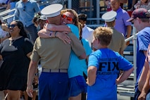A new U.S. Marine with Lima Company, 3rd Recruit Training Battalion, is greeted by a loved one during a graduation ceremony at Marine Corps Recruit Depot San Diego, June 24, 2022.