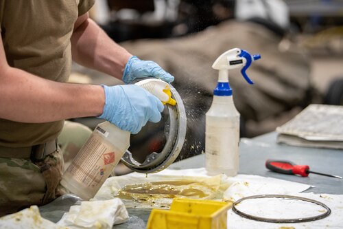 Airmen cleans weapon system part