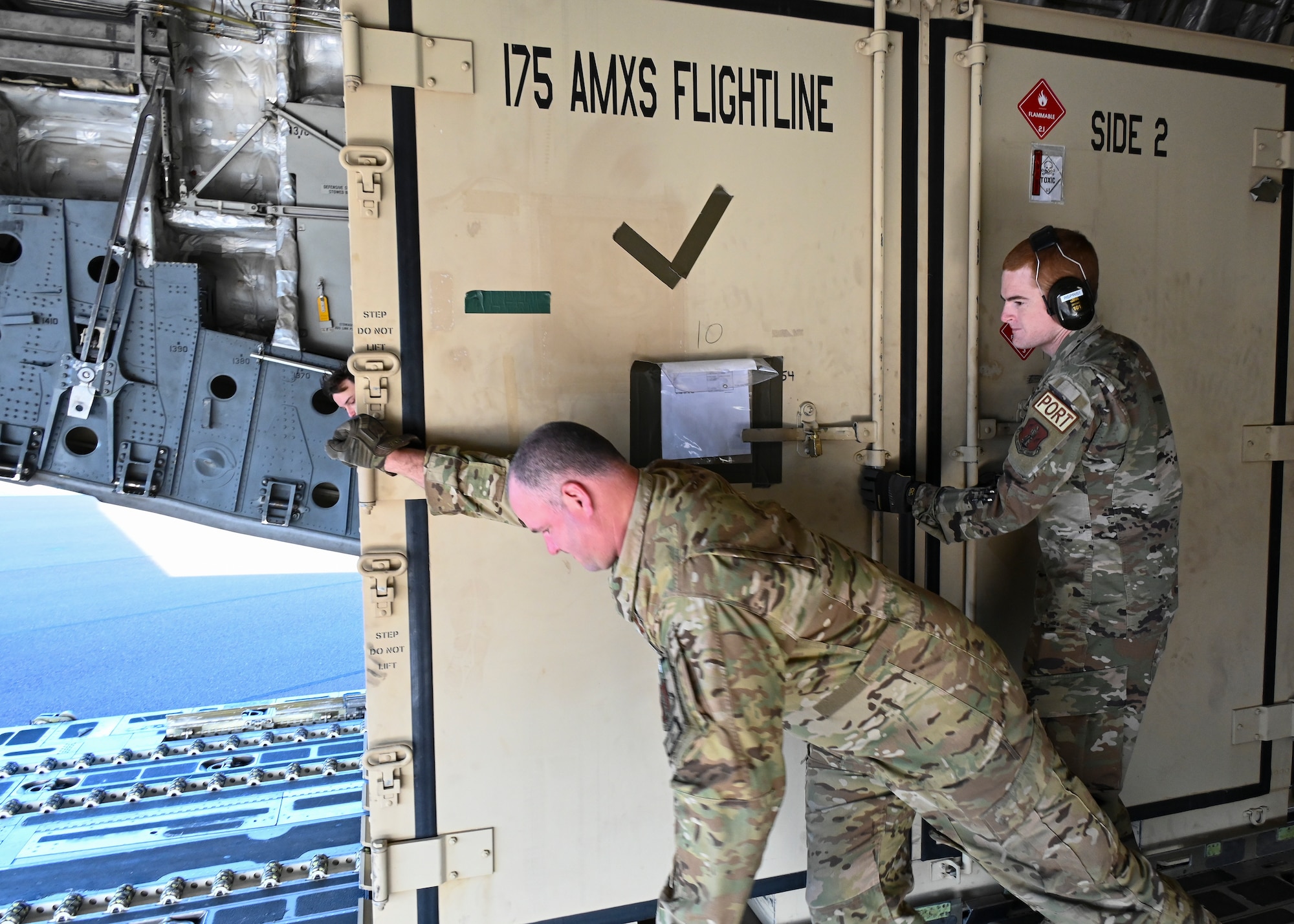 U.S. Air Force Senior Master Sgt. Joseph Windle (left), a loadmaster assigned to the 167th Airlift Wing, West Virginia Air National Guard, and U.S. Air Force Tech. Sgt. Ryan Springer, an air transportation specialist assigned to the 167th Airlift Wing, West Virginia Air National Guard, unload cargo from a C-17 Globemaster III aircraft during the DEFENDER-Europe 22 exercise, May 23, 2022, in Kuressaare, Estonia.