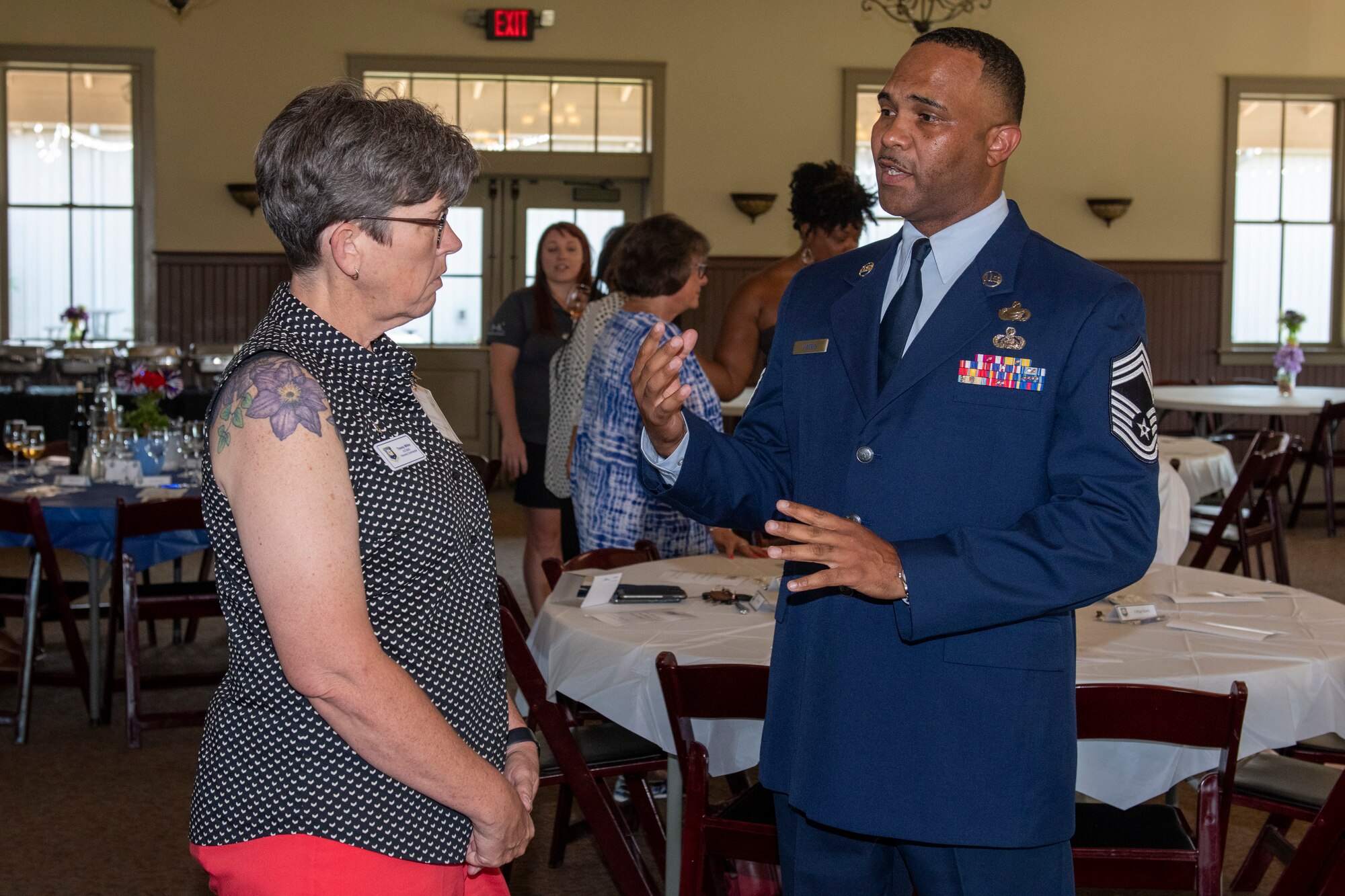 Chief Master Sgt. Anthony Harris, 512th Airlift Wing command chief representative, talks with Tracey Miller from Dedicated to Women during the social hour of the Employer Support of the Guard and Reserve 50th Anniversary Dinner at the Harvest Ridge Winery, Marydel, Delaware, June 29, 2022. Ms. Miller is also an honorary commander assigned to the 512th Maintenance Group. (U.S. Air Force photo by Senior Airman Ruben Rios)