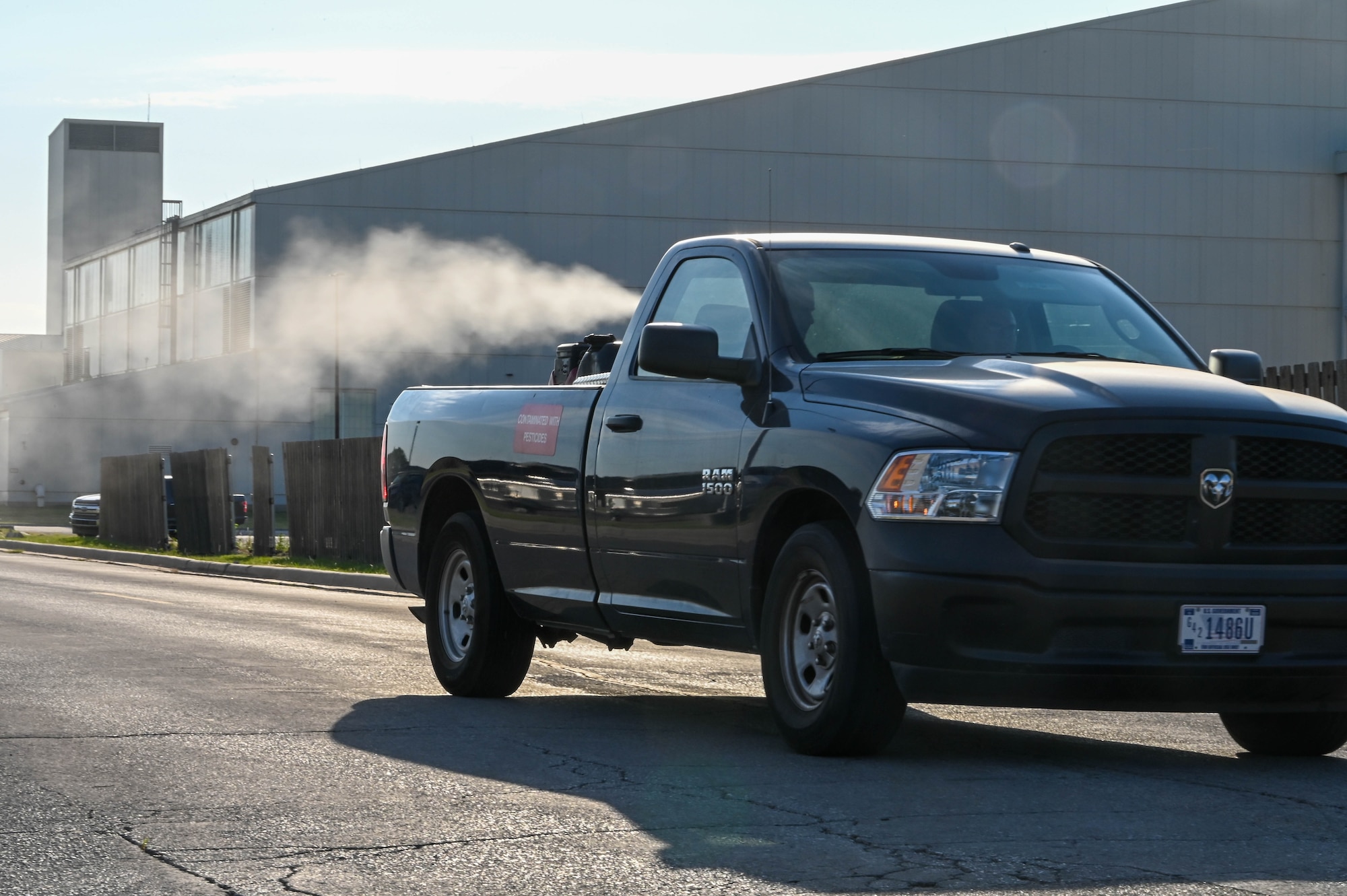 Members from the 97th Civil Engineer Squadron pest control unit fog for mosquitoes at Altus Air Force Base, Oklahoma, June 27, 2022. The mosquito pesticide is safe for mosquito fogging, but Airmen and families are encouraged to stay indoors to avoid being directly in the pathway of the fogging truck. (U.S. Air Force photo by Senior Airman Kayla Christenson)