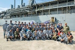SINGAPORE (Jun 29, 2022) – U.S. Navy Sailors assigned to the Emory S. Land-class submarine tender USS Frank Cable (AS 40) and Sailors of the Republic of Singapore Navy pose for a group photo during a bilateral partnership event on the pier, June 29, 2022. Frank Cable is currently on patrol conducting expeditionary maintenance and logistics in support of national security in the U.S. 7th Fleet area of operations. (U.S. Navy photo by Mass Communication Seaman Wendy Arauz)