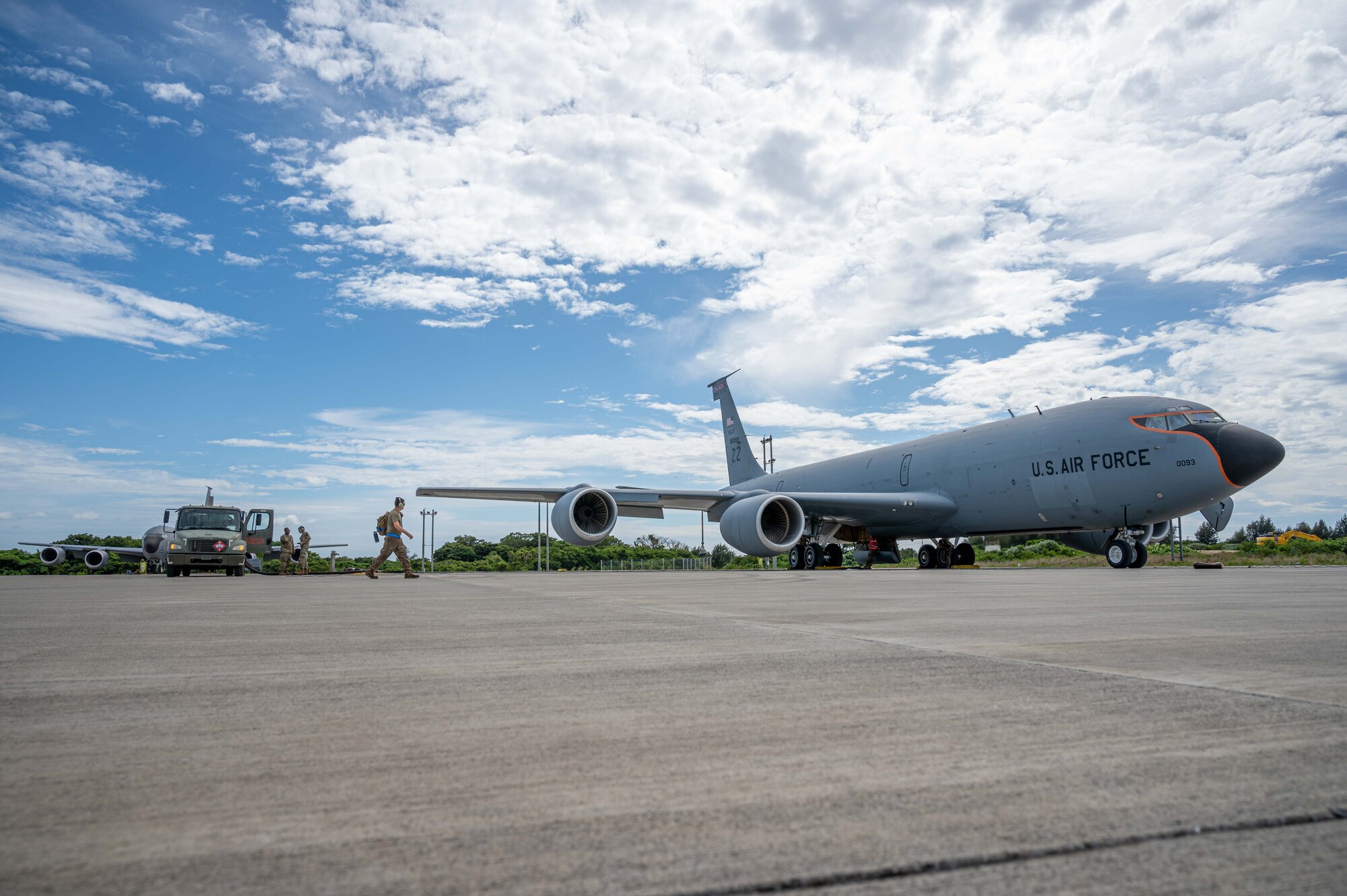 A fuel truck and aircraft are parked while the aircraft is being refueled