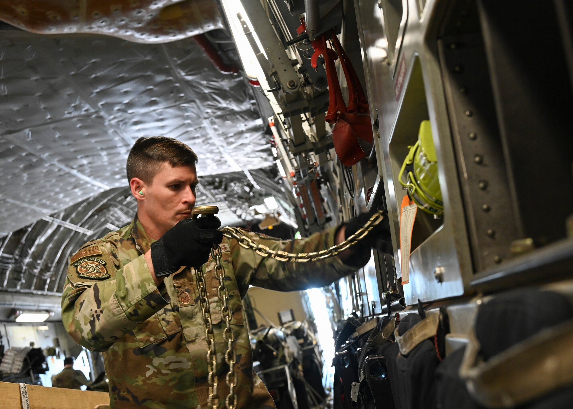 U.S. Air Force Master Sgt. Travis Hall, a crew chief assigned to the 167th Airlift Wing, West Virginia Air National Guard, prepares to unload cargo from a C-17 Globemaster III aircraft during the DEFENDER-Europe 22 exercise, May 23, 2022, in Kuressaare, Estonia.