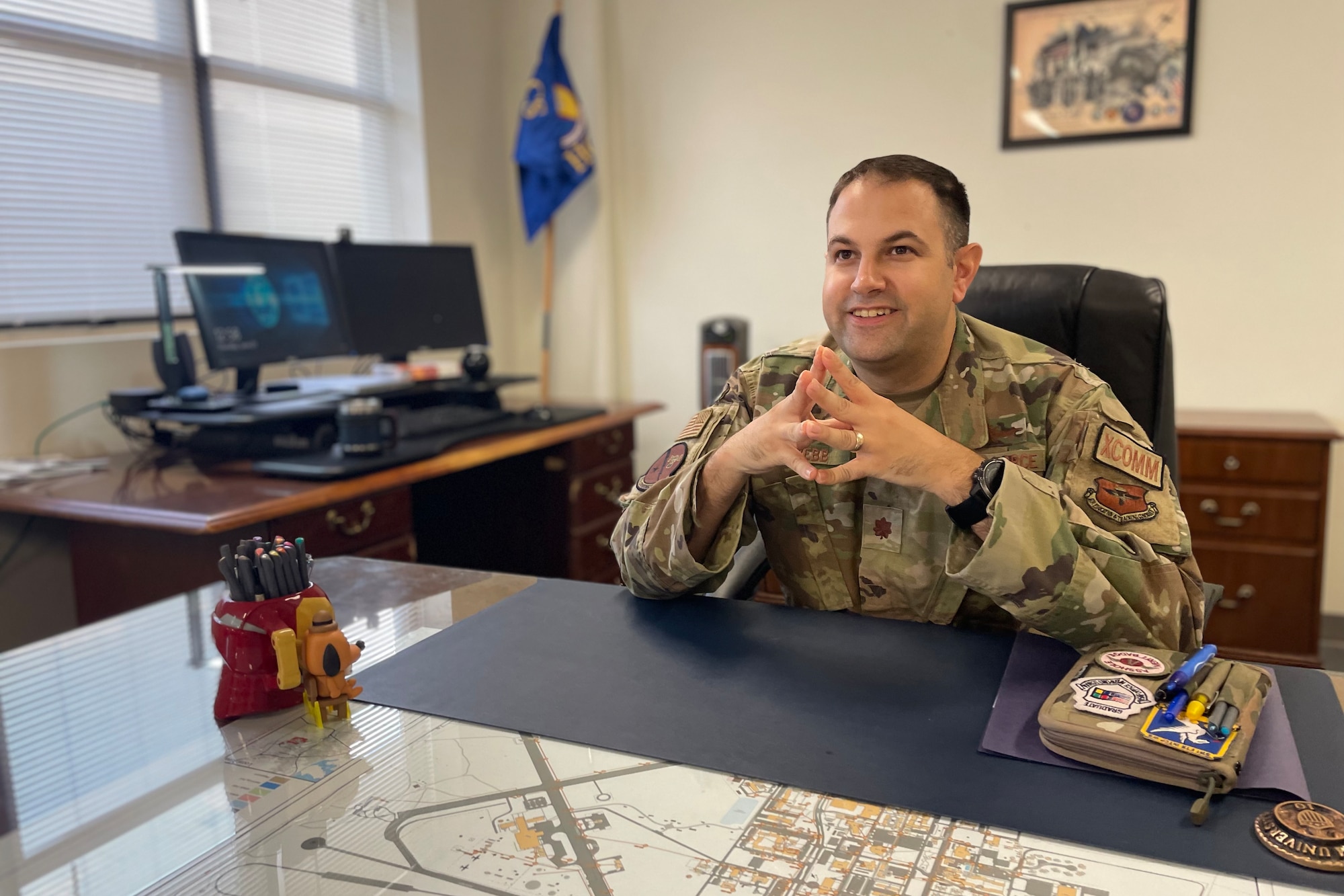 U.S. Air Force Maj. Dexter Webb, 17th Communications Squadron commander, sits in his office, at Goodfellow Air Force Base, Texas, June 23, 2022. Webb earned his commission from Texas A&M University in 2010, and is an expeditionary communications operations officer by trade.  (U.S. Air Force photo by Senior Airman Abbey Rieves)