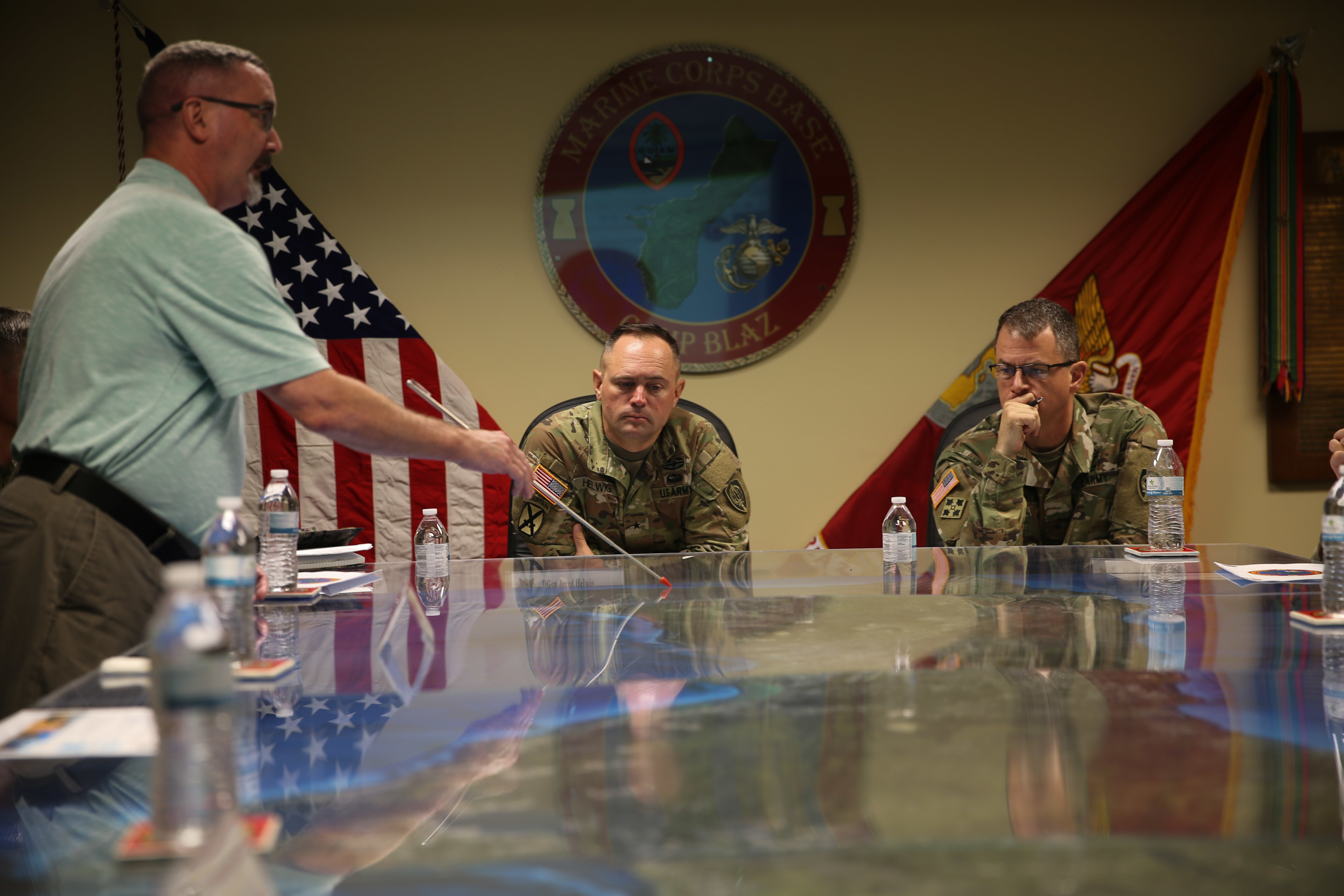 Mr. Donald Baldwin, the chief of staff for Marine Corps Base (MCB) Camp Blaz, left, gives an orientation brief to U.S. Army Brig. Gen. Jared P. Helwig, director of logistics and engineering for U.S Indo-Pacific Command, center, and Brig. Gen. Gavin J. Gardener, incoming director of logistics and engineering for U.S Indo-Pacific Command, right, during a visit to MCB Camp Blaz, Guam, on June 7, 2022. MCB Camp Blaz is a new military installation being built that will support the armed services operating in the Indo-Pacific. (U.S. Marine Corps photo by Lance Cpl. Garrett Gillespie)