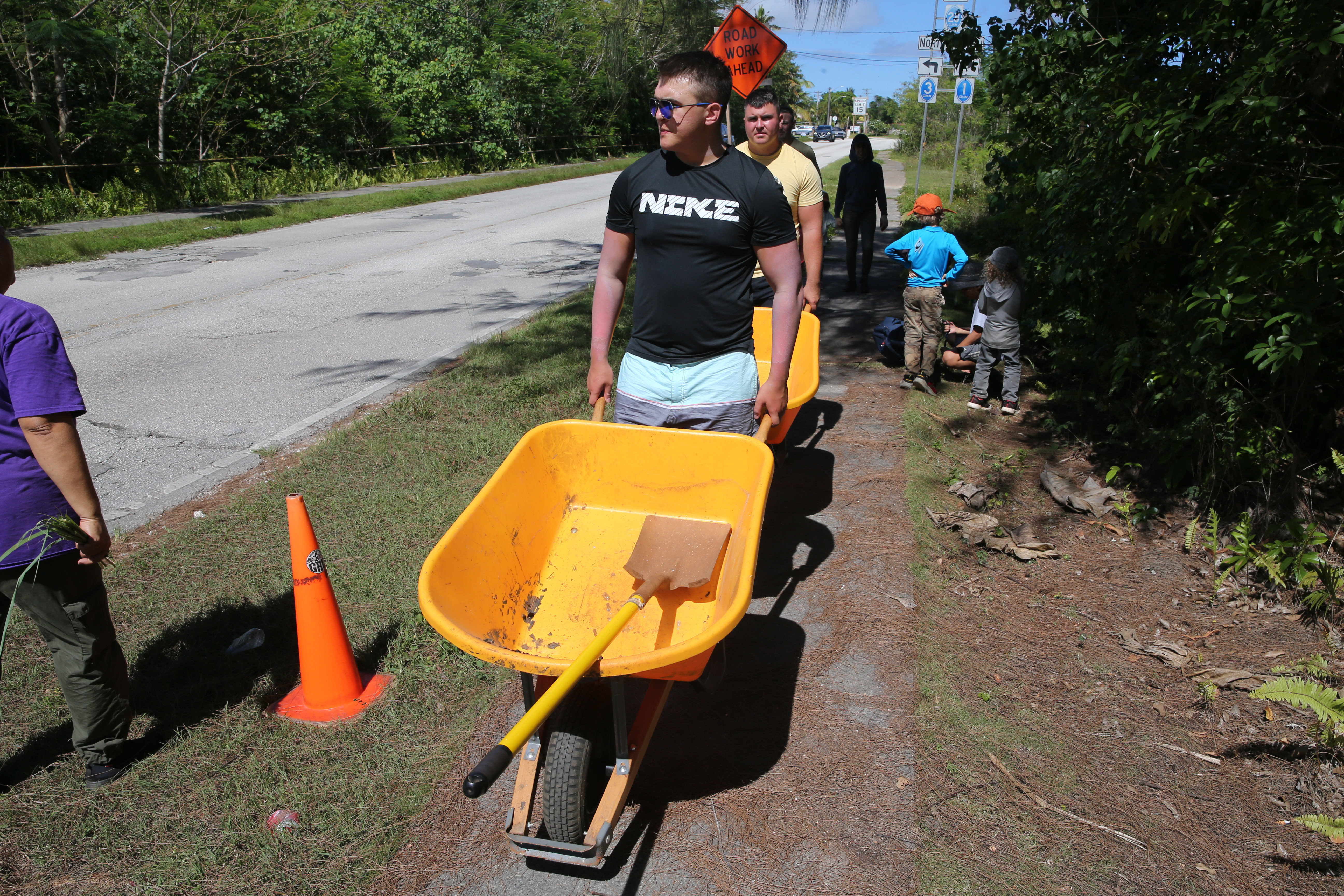 U.S. Marine Corps volunteer help move soil to prepare planting trees in a nature reserve during a volunteer event at the Island Girl Power facility in Dededo, Guam, June 5, 2022. Island Girl Power is a non-profit organization that provides prevention and enrichment programs to young girls and teens in an environment that is safe, empowering and positive. (U.S. Marine Corps photo by Lance Cpl. Garrett Gillespie)