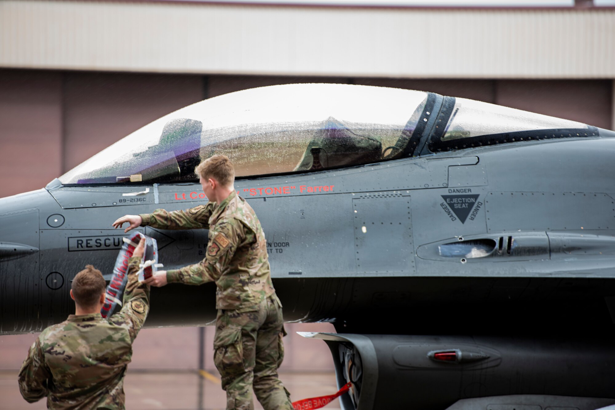 Airmen assigned to the 36th Fighter Squadron reveal a name tape on an F-16 Fighting Falcon for Lt. Col. Cory Farrer, newly appointed 36th Fighter Squadron commander, at Osan Air Base, Republic of Korea, June 30, 2022.