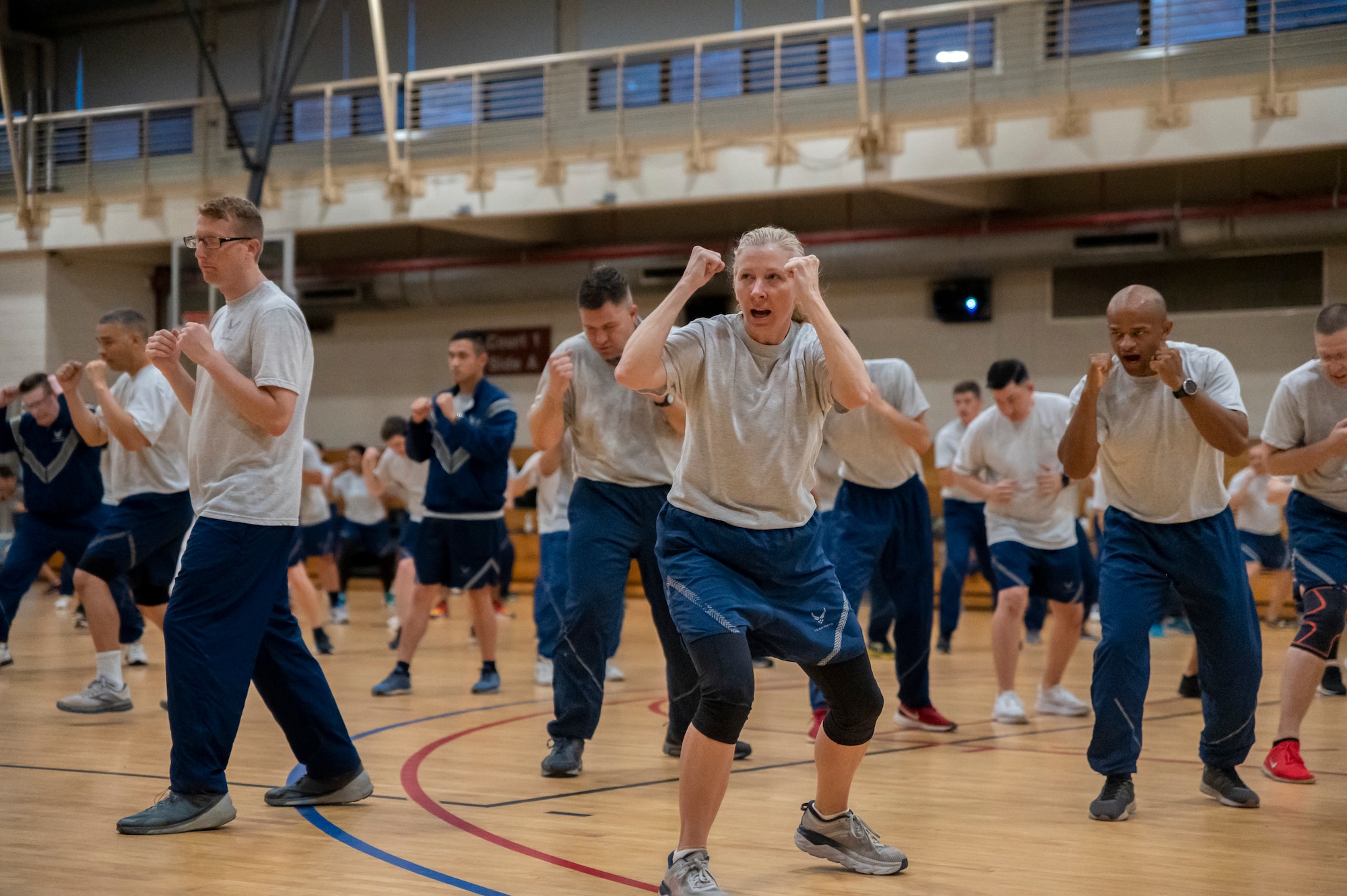 Lt. Col. Elizabeth Eychner, 51st Mission Support Group commander, assumes the combat warrior self-defense position during an MSG physical training session at Osan Air Base, Republic of Korea, June 30, 2022.