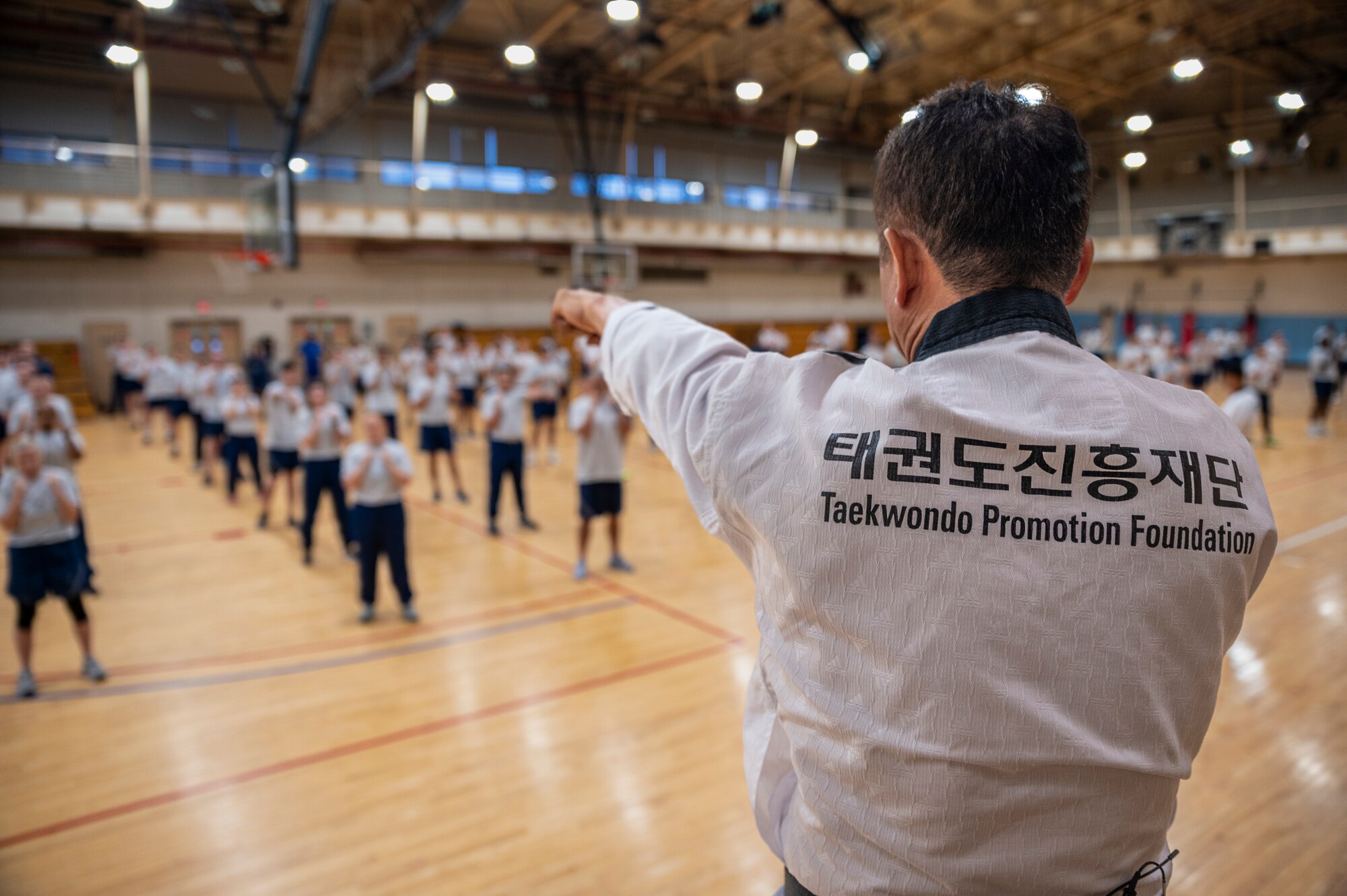 Grandmaster Munok Kim, Taekwondo Promotion Foundation, teaches the 51st Mission Support Group proper Taekwondo punching techniques during an MSG physical training session at Osan Air Base, Republic of Korea, June 30, 2022.