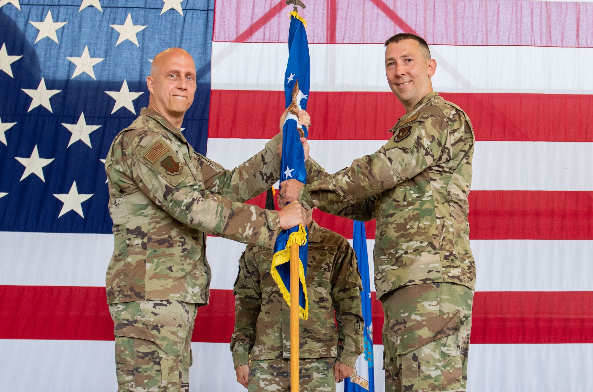 U.S. Air Force Brig. Gen. Joshua M. Olson, 86th Airlift Wing commander, left, hands over command of the 86th Civil Engineer Group to Col. Steven Thomas, 86 CEG incoming commander, during a change of command ceremony at Ramstein Air Base, Germany