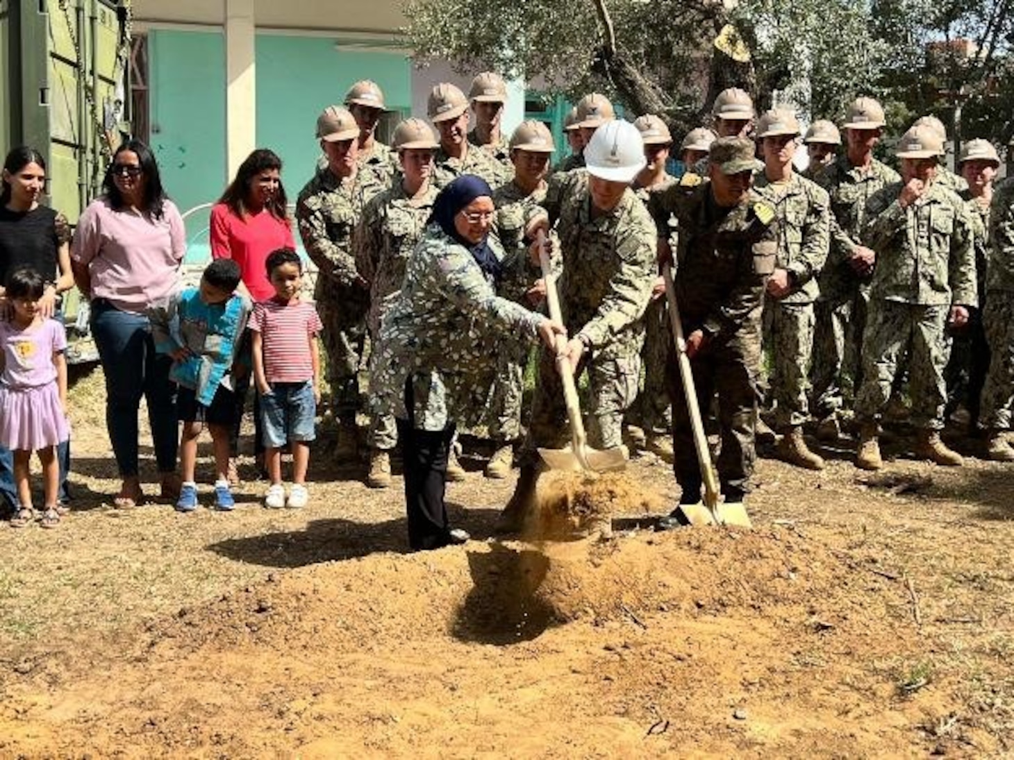 (June 7, 2022) Left to right, School Director Amel Glai, U.S. Navy Lt. j.g. Ramses Carranza, and Tunisian Navy CAPT Naimi Hassen, break ground during a ceremony to mark the start of the construction of a new 130 square meter, two-room kindergarten building with a bathroom at the local elementary school in Bizerte, Tunisia on June 7, 2022. Phoenix Express 22, conducted by U.S. Naval Forces Africa, is a maritime exercise designed to improve cooperation among participating nations in order to increase maritime safety and security in the Mediterranean.