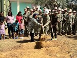 (June 7, 2022) U.S. Navy Seabees assigned to Naval Mobile Construction Battalion 133 pose for a photo with a teacher Reem Glai Hassen at ground breaking ceremony to begin the construction of a new 130 square meter, two-room kindergarten building with a bathroom at the local elementary school in Bizerte, Tunisia on June 7, 2022. Phoenix Express 22, conducted by U.S. Naval Forces Africa, is a maritime exercise designed to improve cooperation among participating nations in order to increase maritime safety and security in the Mediterranean.