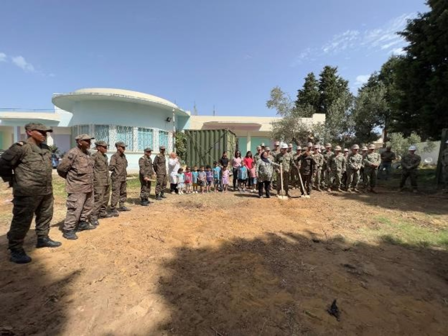 (June 7, 2022) U.S. Navy Seabees assigned to Naval Mobile Construction Battalion 133, Tunisian Navy engineers, along with staff and students attend a ground breaking ceremony to begin the construction of a new 130 square meter, two-room kindergarten building with a bathroom at the local elementary school in Bizerte, Tunisia on June 7, 2022. Phoenix Express 22, conducted by U.S. Naval Forces Africa, is a maritime exercise designed to improve cooperation among participating nations in order to increase maritime safety and security in the Mediterranean.