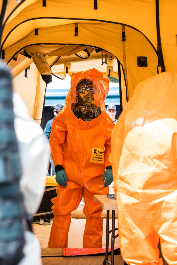 Washington National Guard Staff Sgt. Jordan Cowart, 10th Civil Support Team, awaits decontamination following entry into a training lane in Bellevue, Wash., June 16, 2022. The 10th CST trained with the FBI, the Bellevue Fire Department and the U.S. Army Edgewood Chemical Biological Center.