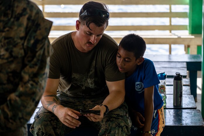 U.S. Navy Hospital Corpsmen 2nd Class Aaron Johnson with Task Force Koa Moana 22, I Marine Expeditionary Force, demonstrates the different parts of his multi-tool to a camper participating in the Division of Juvenile Justice’s Omesuub Ngosisechakl Emesmechokl Law Enforcement Explorers Program in Ngeremlengui, Republic of Palau, June 23, 2022. Omesuub Ngosisechakl Emesmechokl in the native language translates to learning, teaching and discipline, traits that are exemplified by the Marines and Sailors strengthening U.S. partnerships through subject matter expert exchanges. Named “Koa Moana,” after a Hawaiian/Polynesian phrase meaning “ocean warrior,” the task force fosters peace and security, builds relationships, and supports an international rules-based order that benefits the Indo-Pacific region.