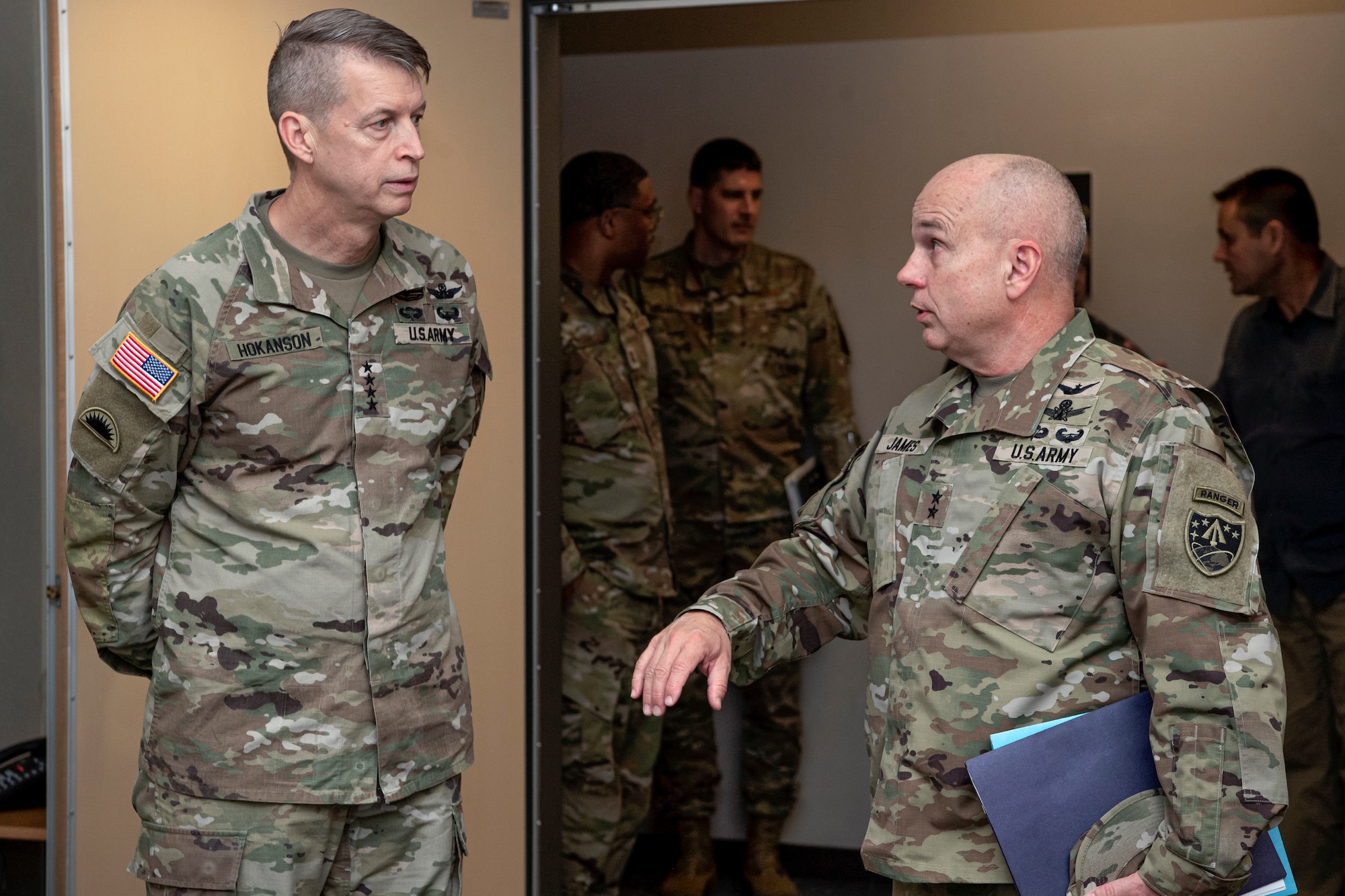 two military members talking