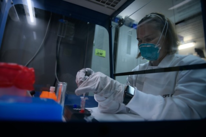 A soldier prepares a sample for COVID-19 testing.