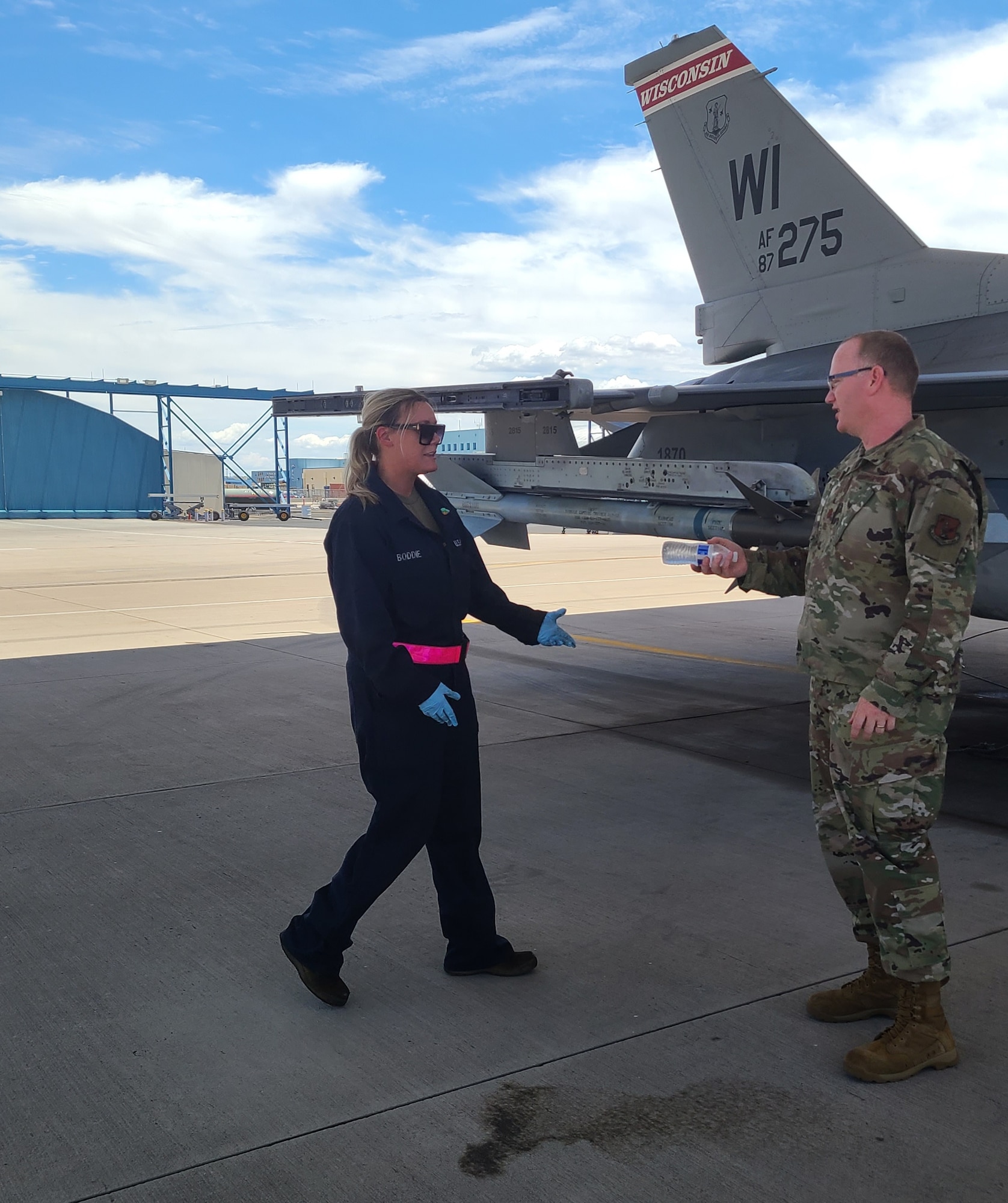 Maj. Nathan Mestler, 162nd Wing chaplain, hands out water to thirsty maintenance personnel on the flightline during the hot summer months.