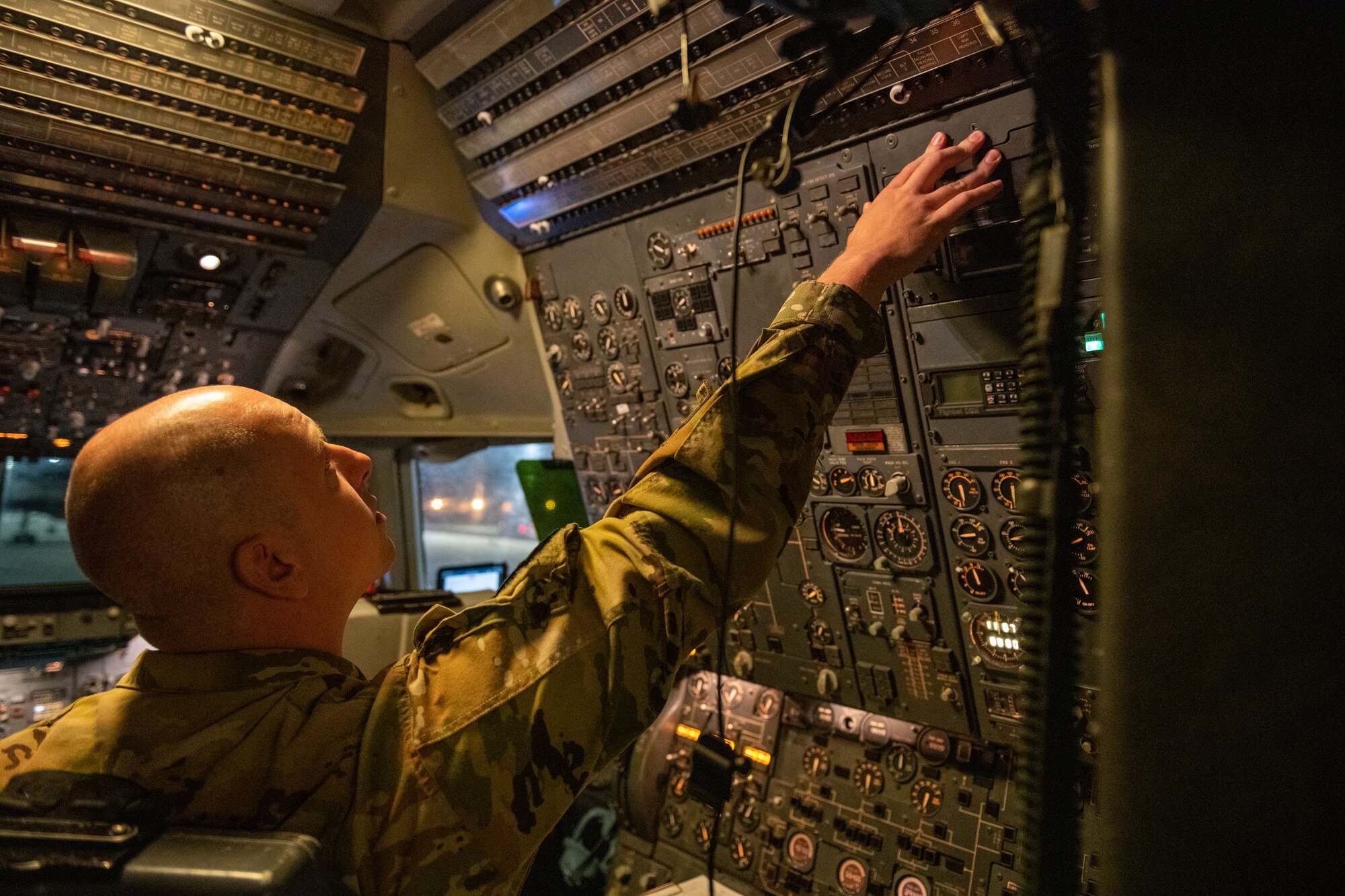 flight engineer conducts pre-flight operations on KC-10