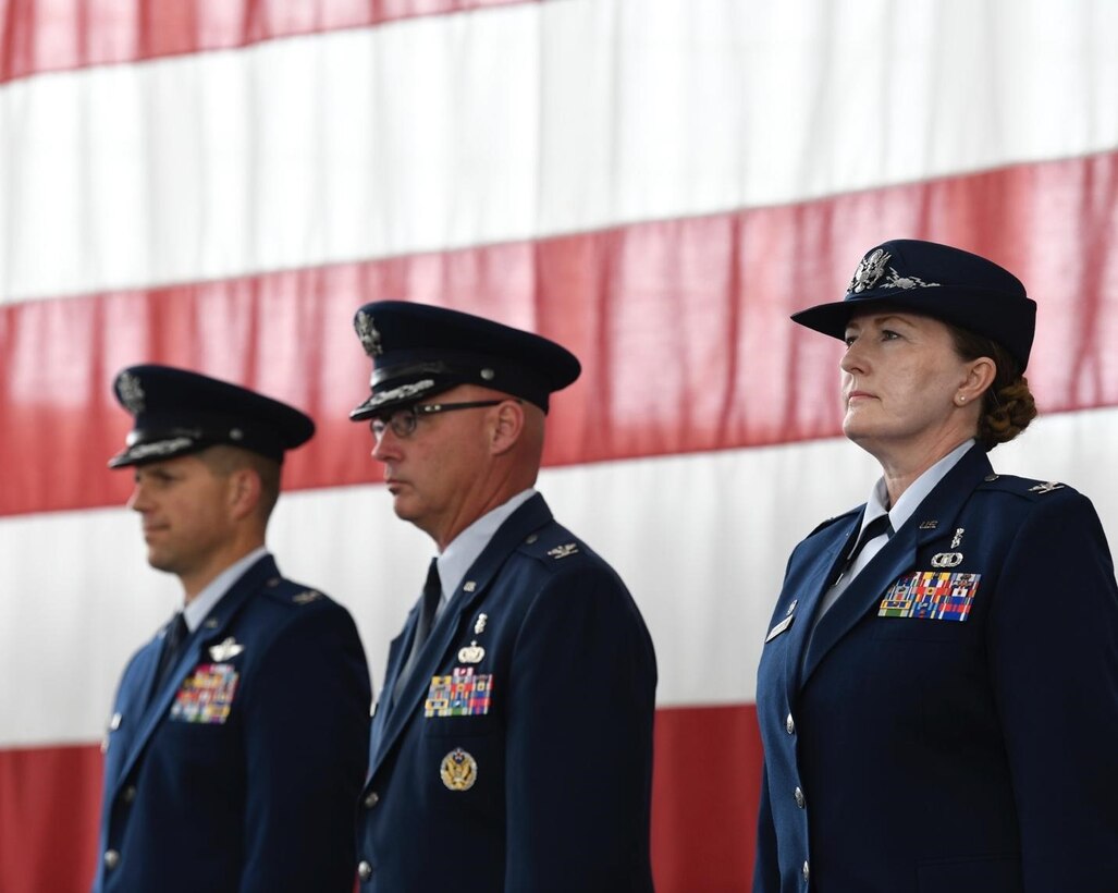 Col. Seth Spanier, the 28th Bomb Wing vice commander, left, Col. Robert Corby, the outgoing 28th Medical Group commander, middle, and Col. Michelle Schnakenberg, the incoming 28th Medical Group commander, right, stand for the commencement of the change of command ceremony at Ellsworth Air Force Base, S.D., July 06, 2022.
