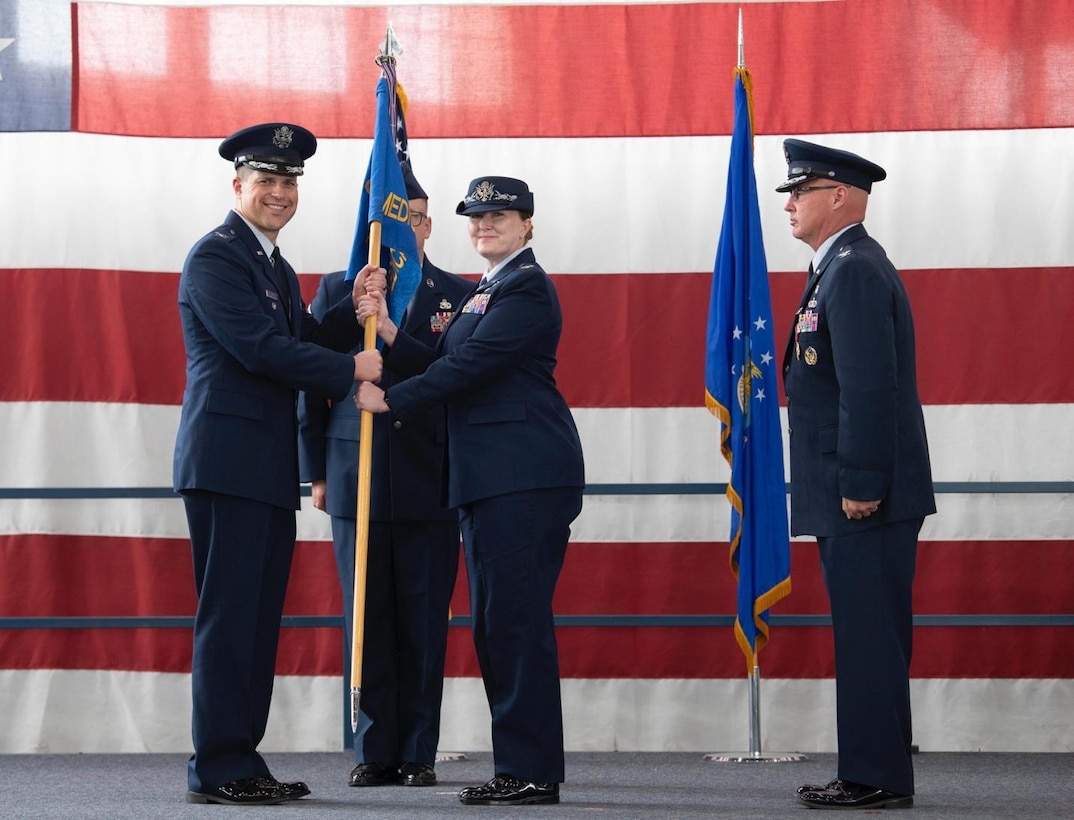 Col. Michelle Schnakenberg, the incoming 28th Medical Group commander, receives the 28th Medical Group’s guidon from Col. Seth Spanier, the 28th Bomb Wing vice commander, at Ellsworth Air Force Base, S.D., July 06, 2022.