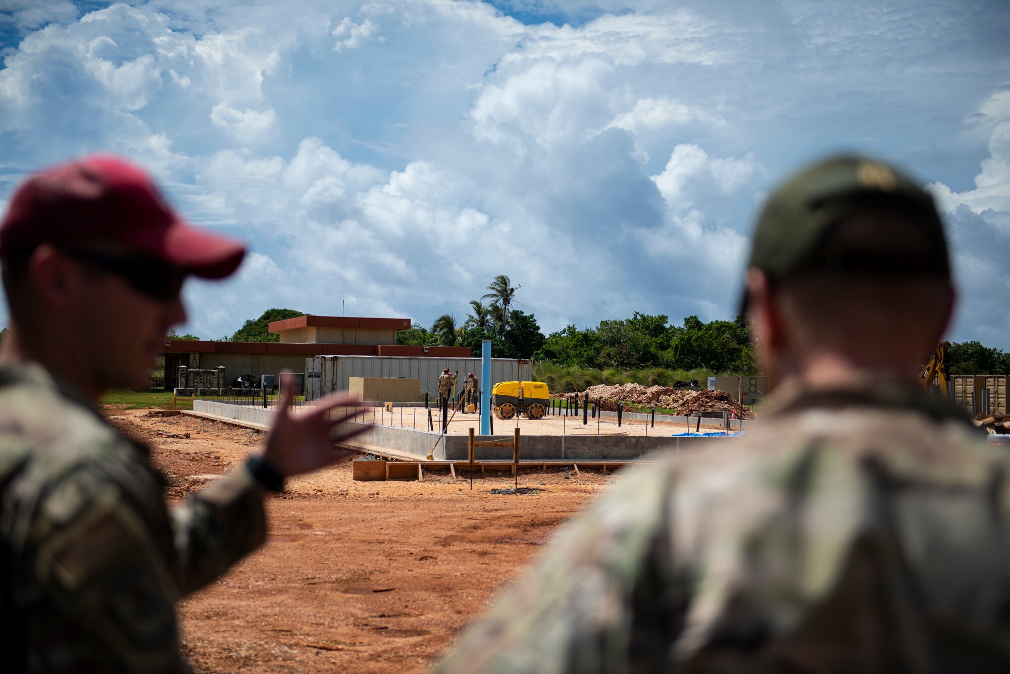 U.S. Air Force Tech. Sgt. Xavier Gemba, 554th Rapid Engineer Deployable Heavy Operational Repair Squadron Engineers design and engineering noncommissioned officer in charge, briefs Brig. Gen. Paul Birch, 36th Wing commander, about future projects during an immersion tour at Andersen Air Force Base, Guam, June 23, 2022. Members from the 554 RED HORSE talked about difficulties they experience and temporary solutions. (U.S. Air Force photo by Staff Sgt. Suzie Plotnikov)