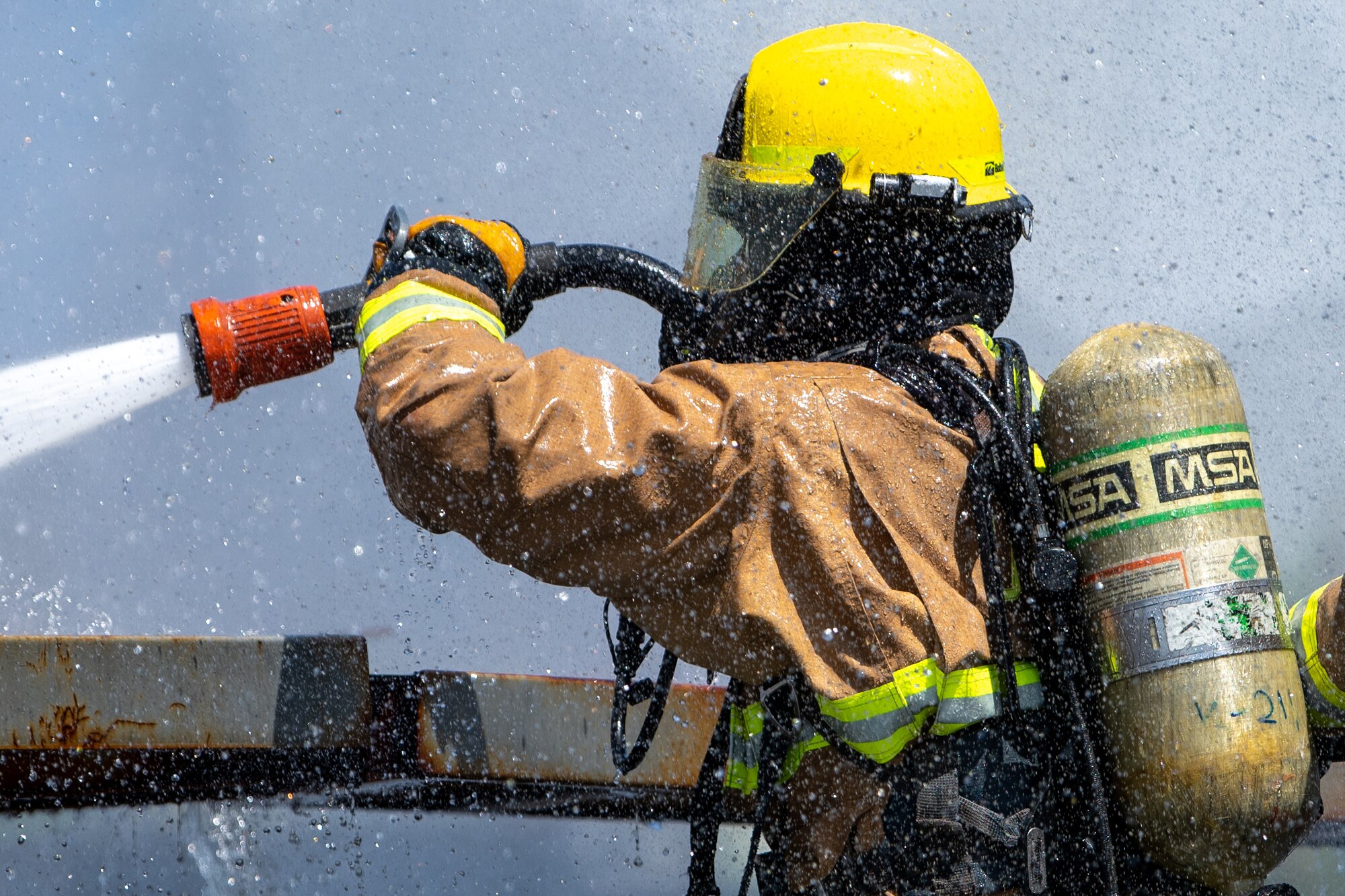 A firefighter extinguishes a fire.