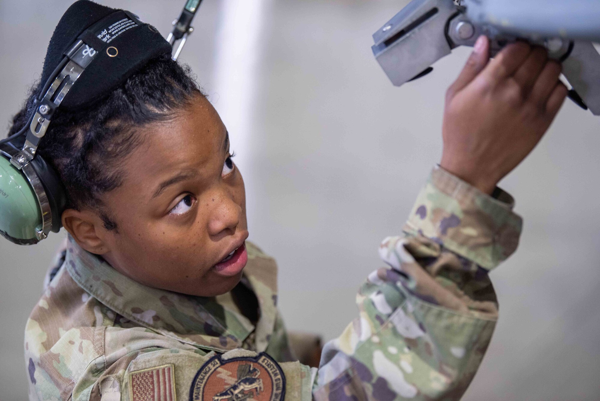 U.S. Air Force Airman 1st Class Jazmine Harrington, 14th Aircraft Maintenance Unit weapons load team member, tightens a bolt on an F-16 Fighting Falcon during the second quarter load crew competition at Misawa Air Base, Japan, July 1, 2022.