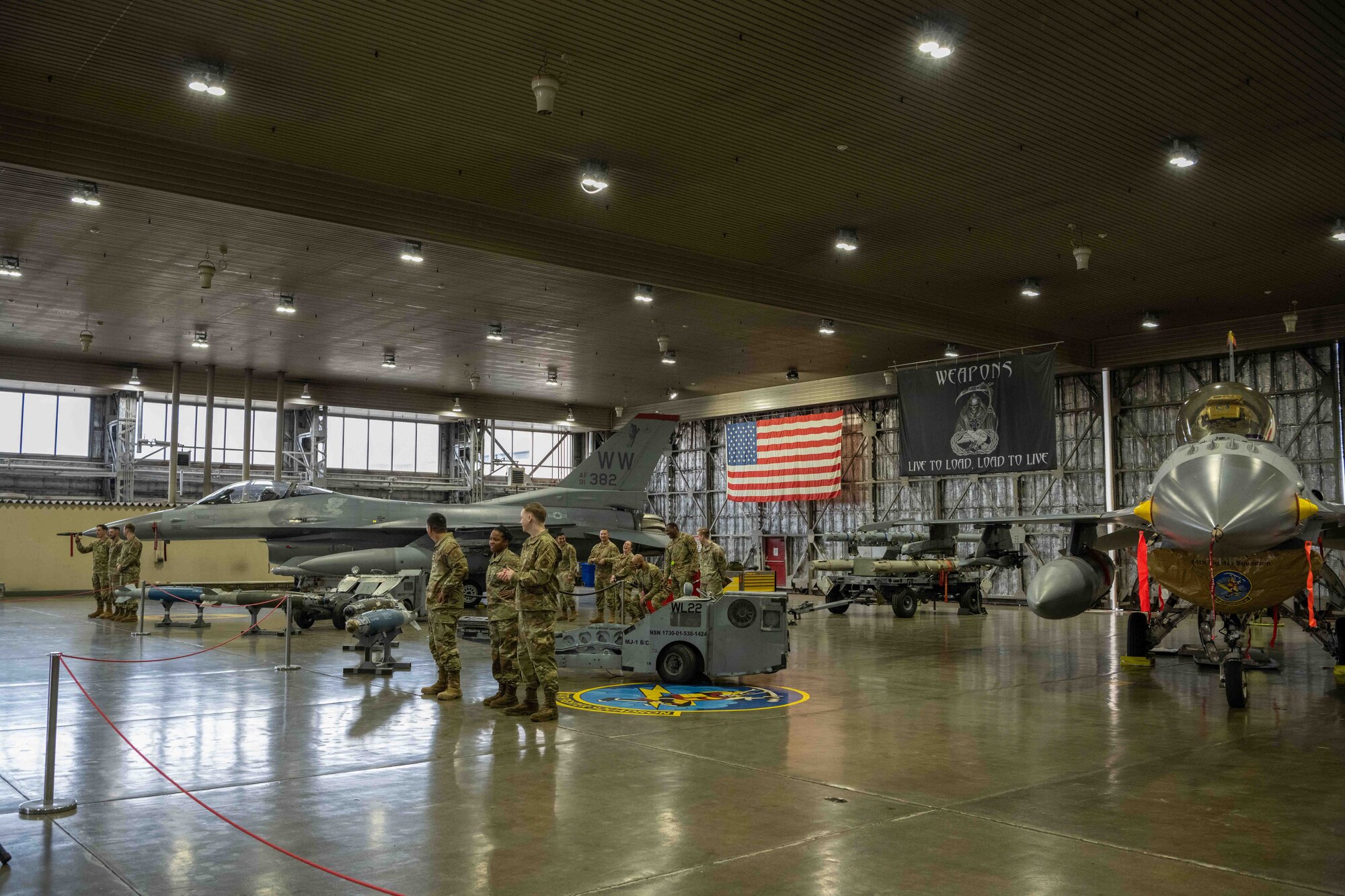 U.S. Air Force Airmen assigned to the 13th and 14th Aircraft Maintenance Units stand at ease prior to the second quarter load crew competition at Misawa Air Base, Japan, July 1, 2022.