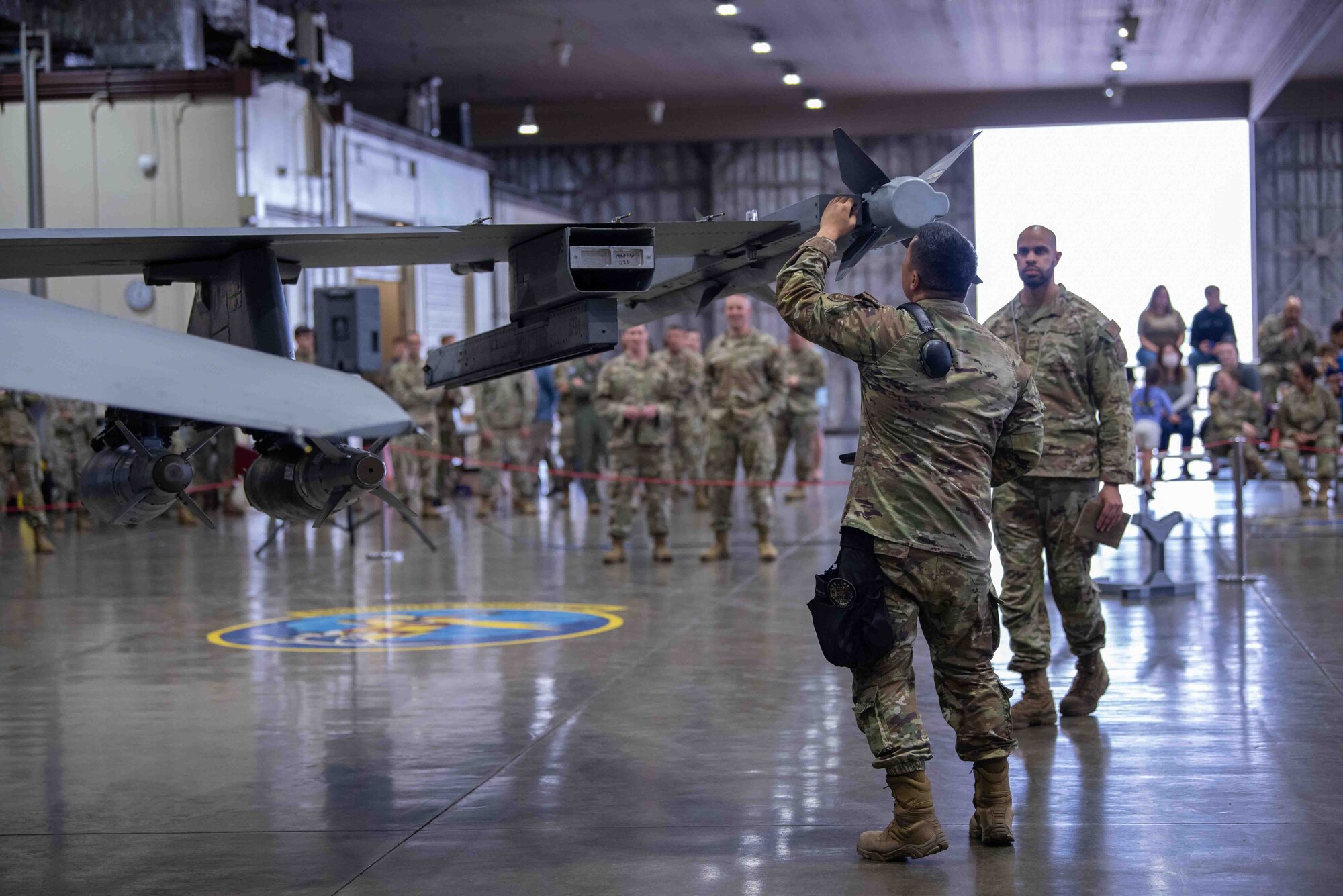 U.S. Air Force Staff Sgt. Anferne Phrachansiri, 14th Aircraft Maintenance Unit weapons load team chief, conducts an inspection of a AIM-9X Sidewinder after loading it onto a F-16 Fighting Falcon during the second quarter load crew competition at Misawa Air Base, Japan, July 1, 2022.