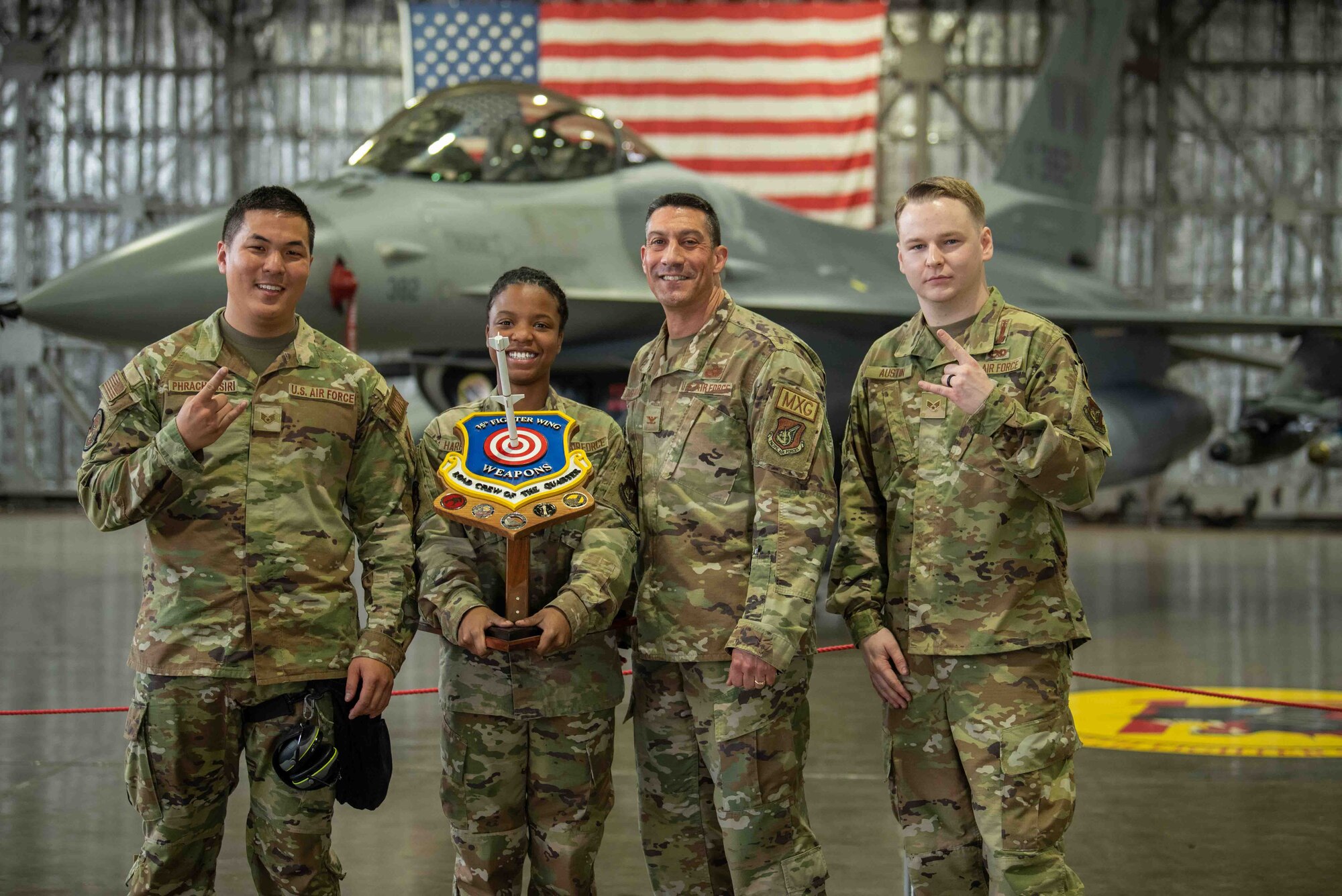 U.S. Air Force Airmen with the 14th Aircraft Maintenance Unit (AMU) pose for a photo with their leadership after winning the second quarter load crew competition at Misawa Air Base, Japan, July 1, 2022.