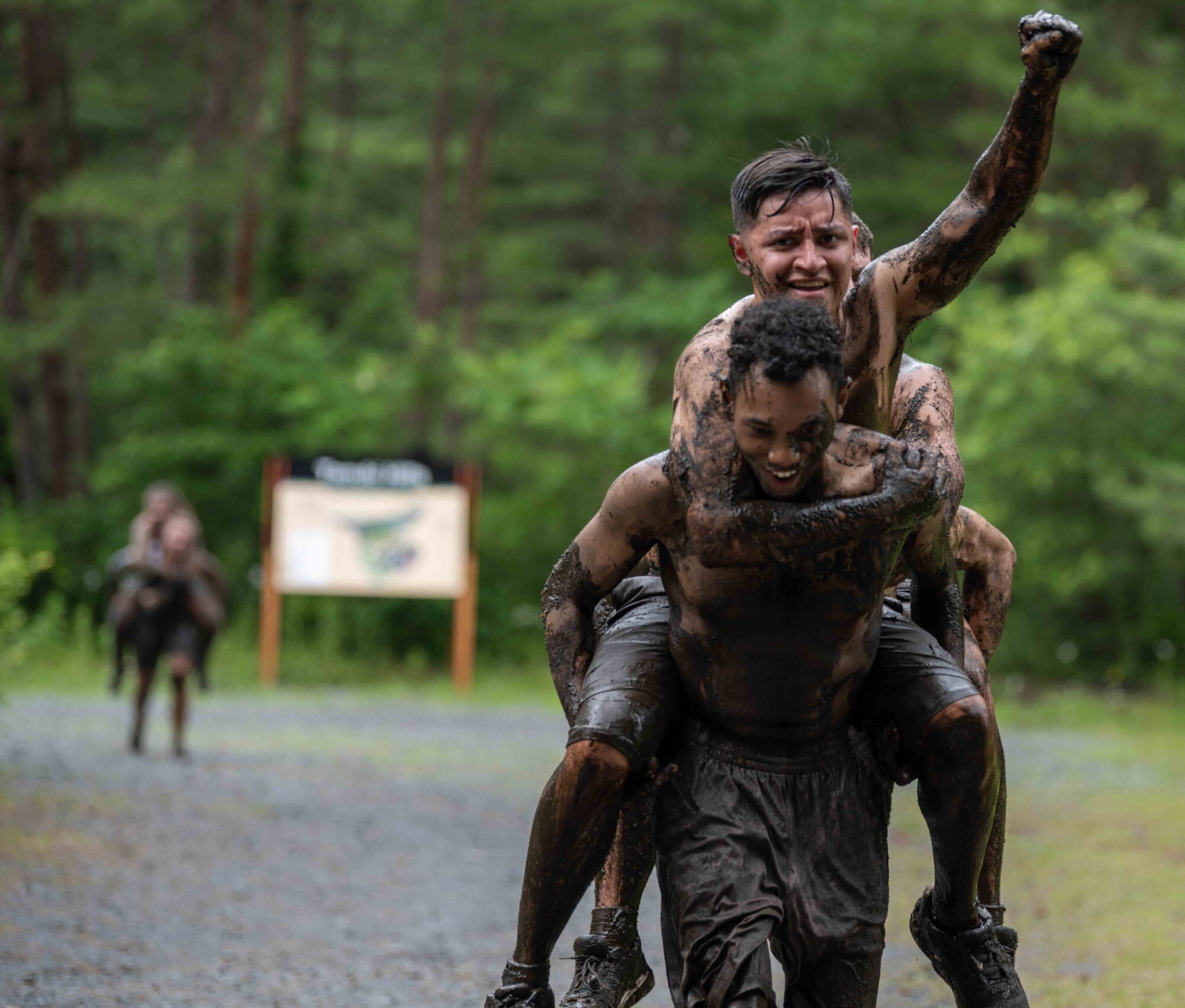 Participants celebrate crossing the finish line during the annual Misawa Mudder at Misawa Air Base, Japan, July 2, 2022.