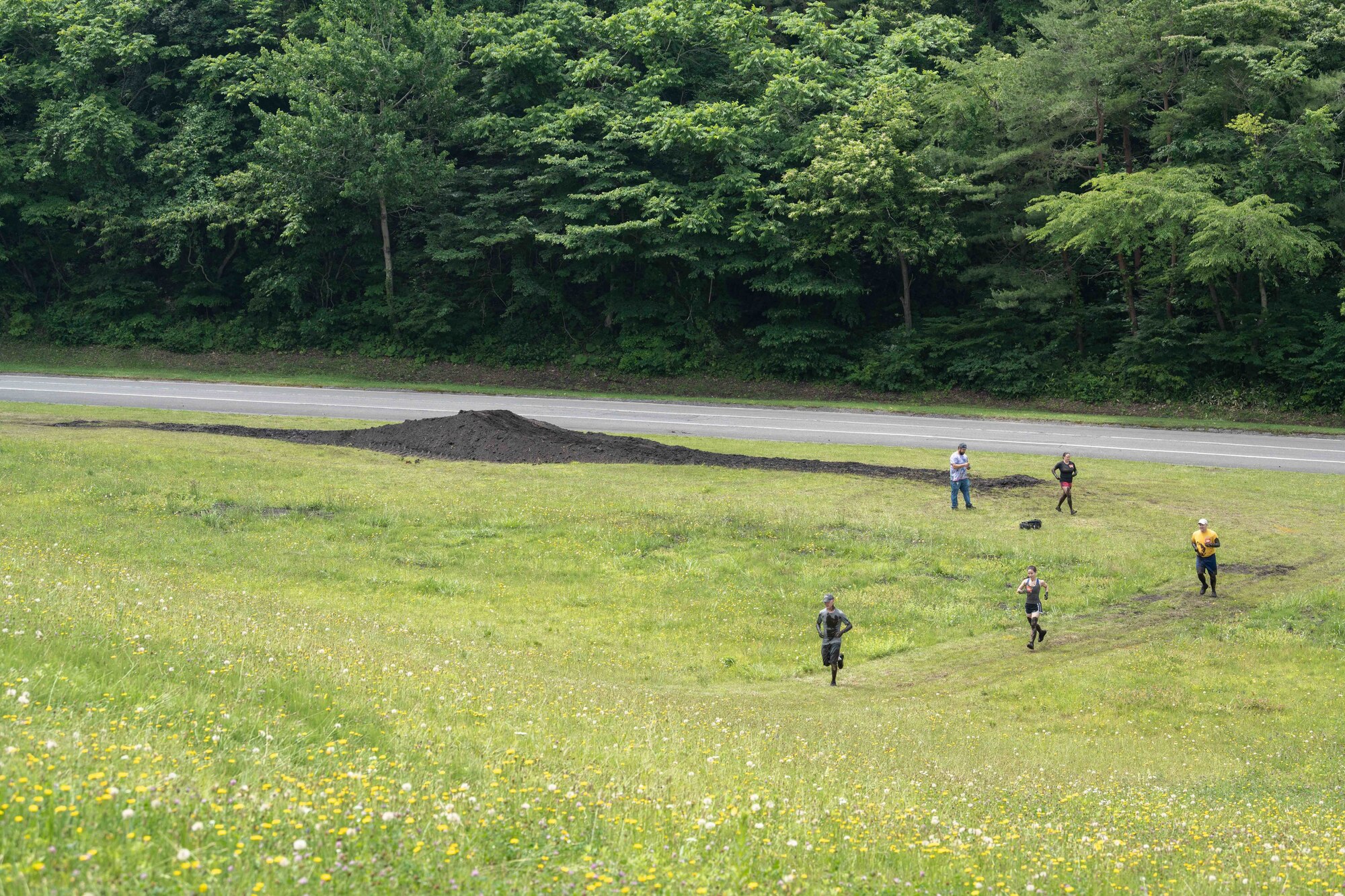 Members from Team Misawa run during the annual Misawa Mudder at Misawa Air Base, Japan, July 2, 2022.