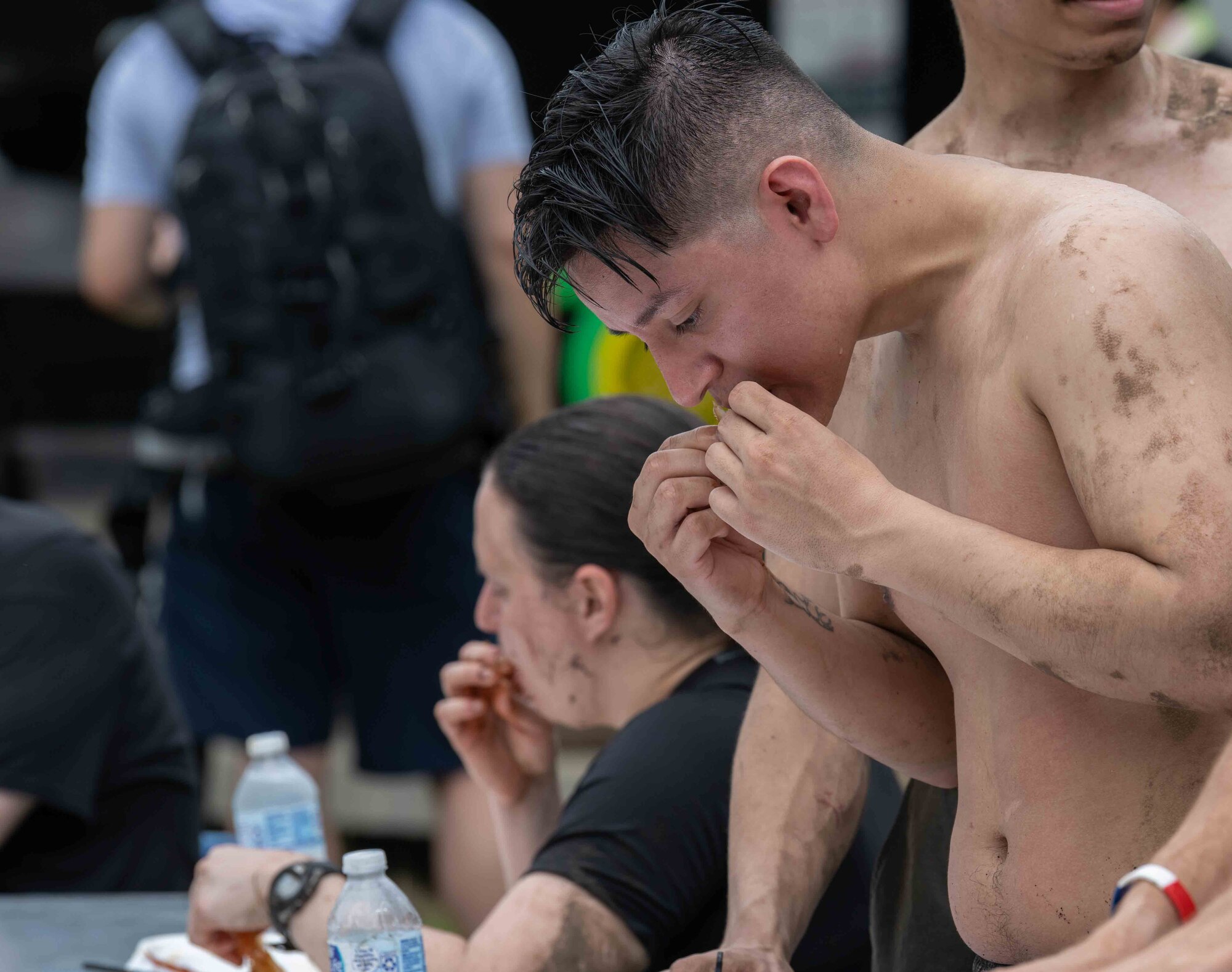 A member of Team Misawa eats a crab leg during the annual Misawa Mudder at Misawa Air Base, Japan, July 2, 2022.