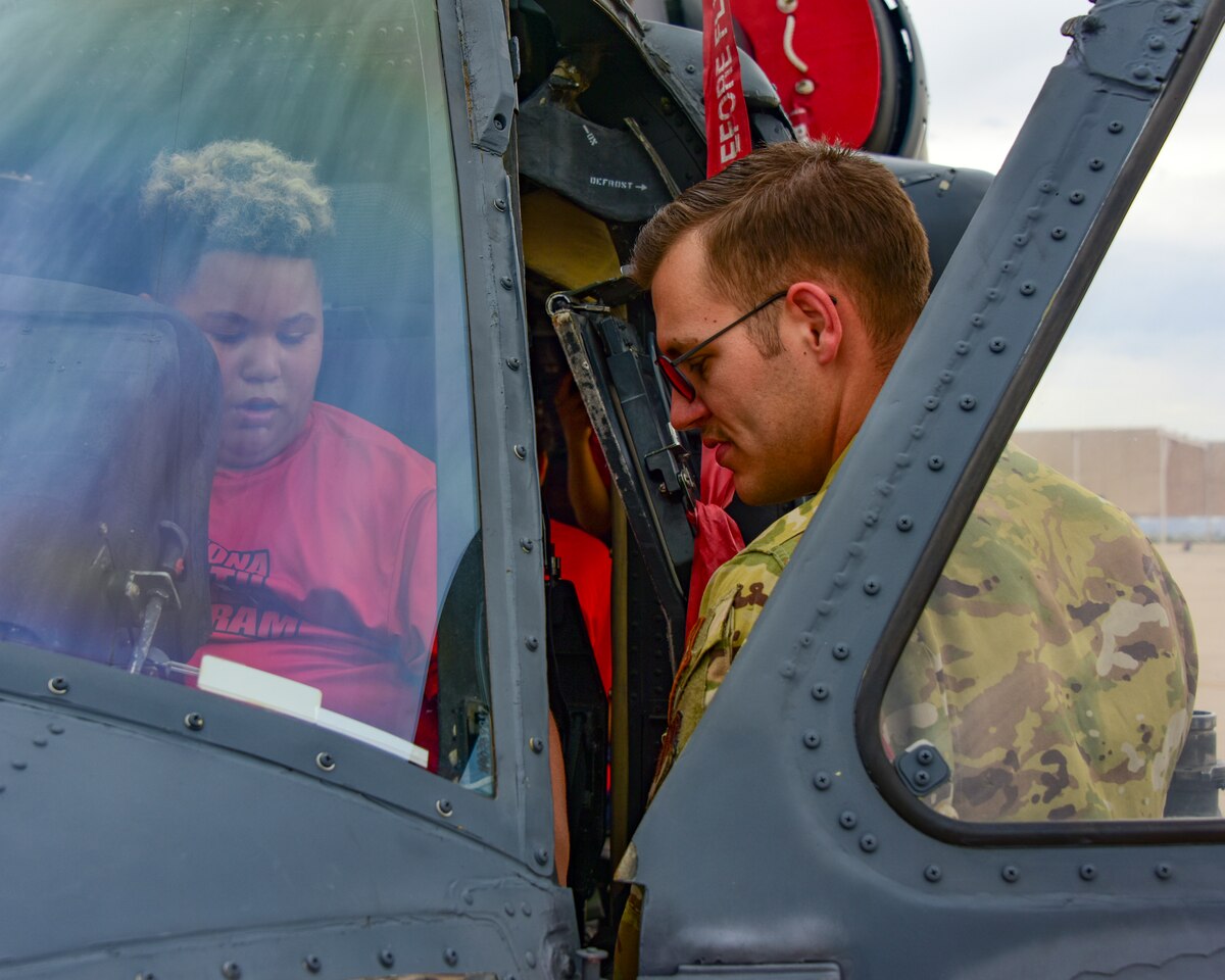 A photo of a man talking to a child in a helicopter