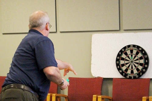 Dr. Michael Gregg, Air Force Research Laboratory digital transformation director, tosses a ceremonial dart to officially release the Digital Accelerator for Research Transformation effort, DART 1.0, to the AFRL workforce at Wright-Patterson Air Force Base, Ohio, June 30, 2022. DART is an online library with new products, capabilities and solutions offered to the workforce on a quarterly basis in support of the lab’s digital transformation efforts. (U.S. Air Force photo / Kati Cospy)