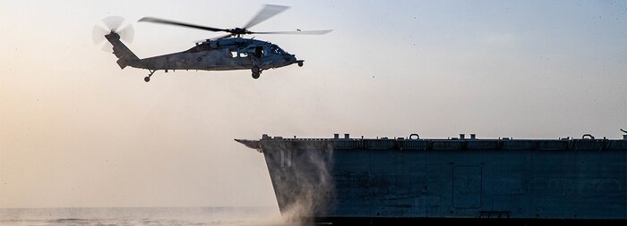 An MH-60S Sea Hawk helicopter assigned to the “Sea Knights” of Helicopter Sea Combat squadron (HSC 22) approaches the littoral combat ship USS Sioux City (LCS 11), while operating in the Gulf of Aden.