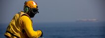 Aviation Boatswains Mate (Handling) 2nd Class Marcus Hayward observes flight operations aboard the expeditionary sea base USS Lewis B. Puller (ESG 3), during exercise Iron Defender in the Arabian Gulf.