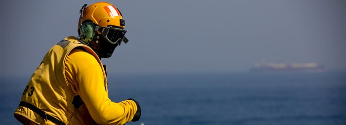 Aviation Boatswains Mate (Handling) 2nd Class Marcus Hayward observes flight operations aboard the expeditionary sea base USS Lewis B. Puller (ESG 3), during exercise Iron Defender in the Arabian Gulf.