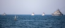 A Saildrone Explorer unmanned surface vessel, littoral combat ship USS Sioux City (LCS 11), and U.S. Coast Guard cutters USCGC Baranof (WPB 1318) and USCGC Robert Goldman (WPC 1142) and coastal patrol ship USS Thunderbolt (PC 12) sail in the Arabian Gulf.