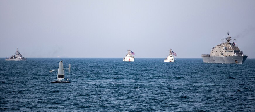 A Saildrone Explorer unmanned surface vessel, littoral combat ship USS Sioux City (LCS 11), and U.S. Coast Guard cutters USCGC Baranof (WPB 1318) and USCGC Robert Goldman (WPC 1142) and coastal patrol ship USS Thunderbolt (PC 12) sail in the Arabian Gulf.