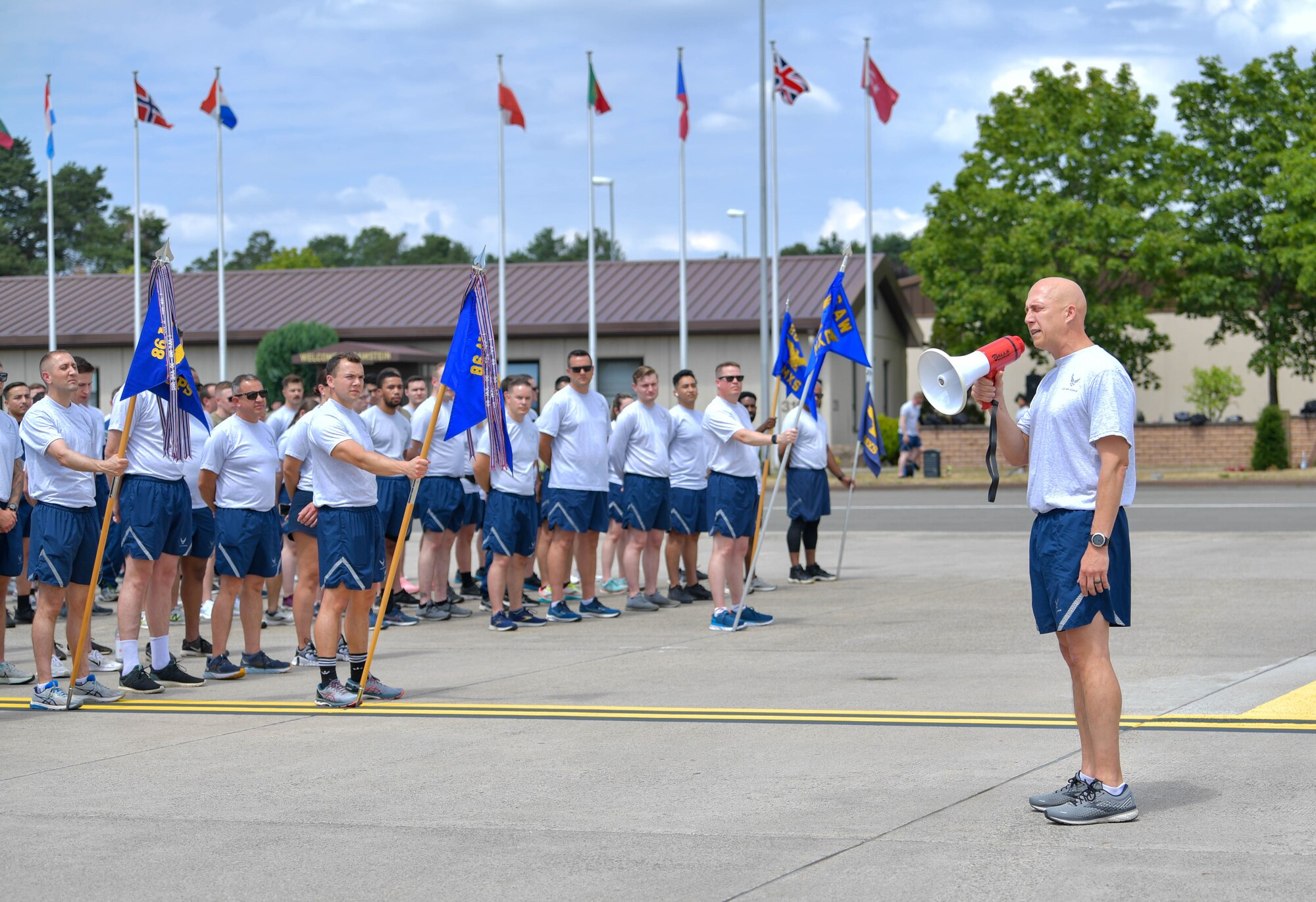 U.S. Air Force Brig. Gen. Josh Olson, 86th Airlift Wing commander, right, addresses members of the wing during a wing run at Ramstein Air Base, Germany, June 29, 2022.