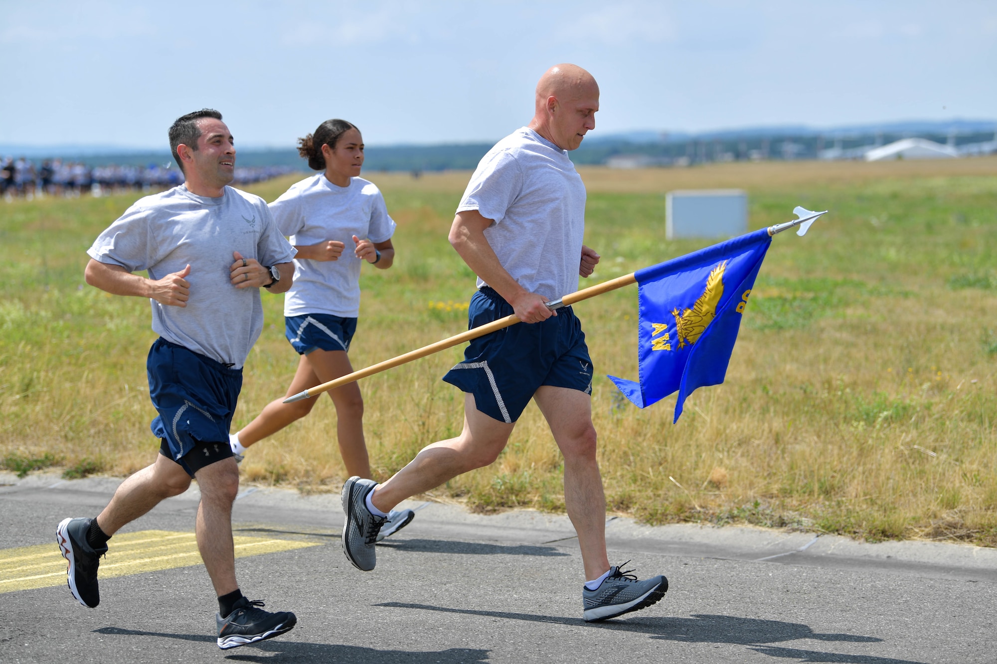 U.S. Air Force Brig. Gen. Josh Olson, 86th Airlift Wing commander, right, runs with 86 AW Airmen during a wing run at Ramstein Air Base, Germany, June 29, 2022.