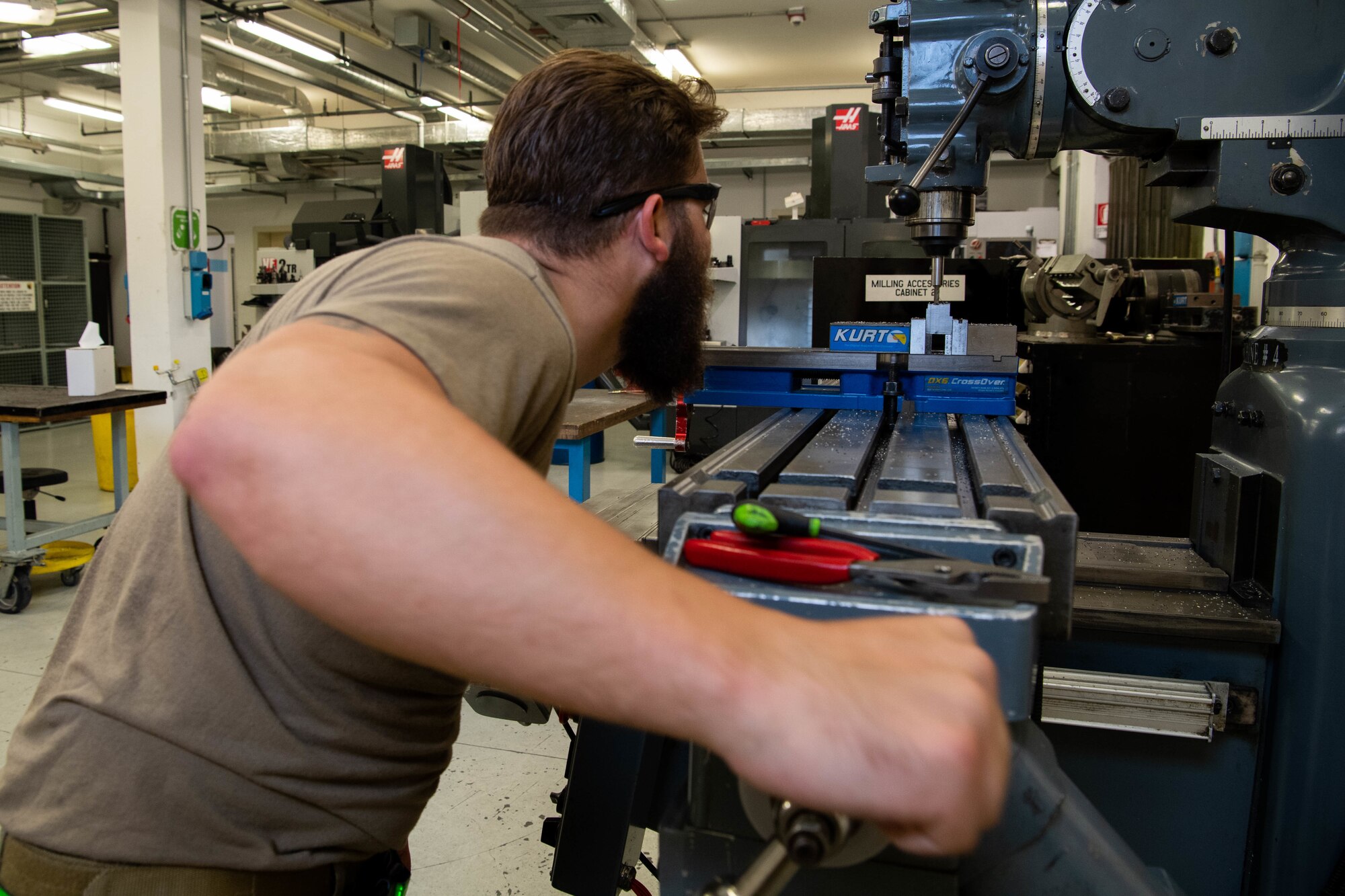 Staff Sgt. Branagan Glennen, 31st Maintenance Squadron metals technician craftsman, cuts a piece of metal using a mill  at Aviano Air Base, Italy, July 6, 2022. The mill is often used to fabricate aircraft parts and locally manufacture tools for different squadrons on Aviano. (U.S. Air Force photo by Senior Airman Noah Sudolcan)