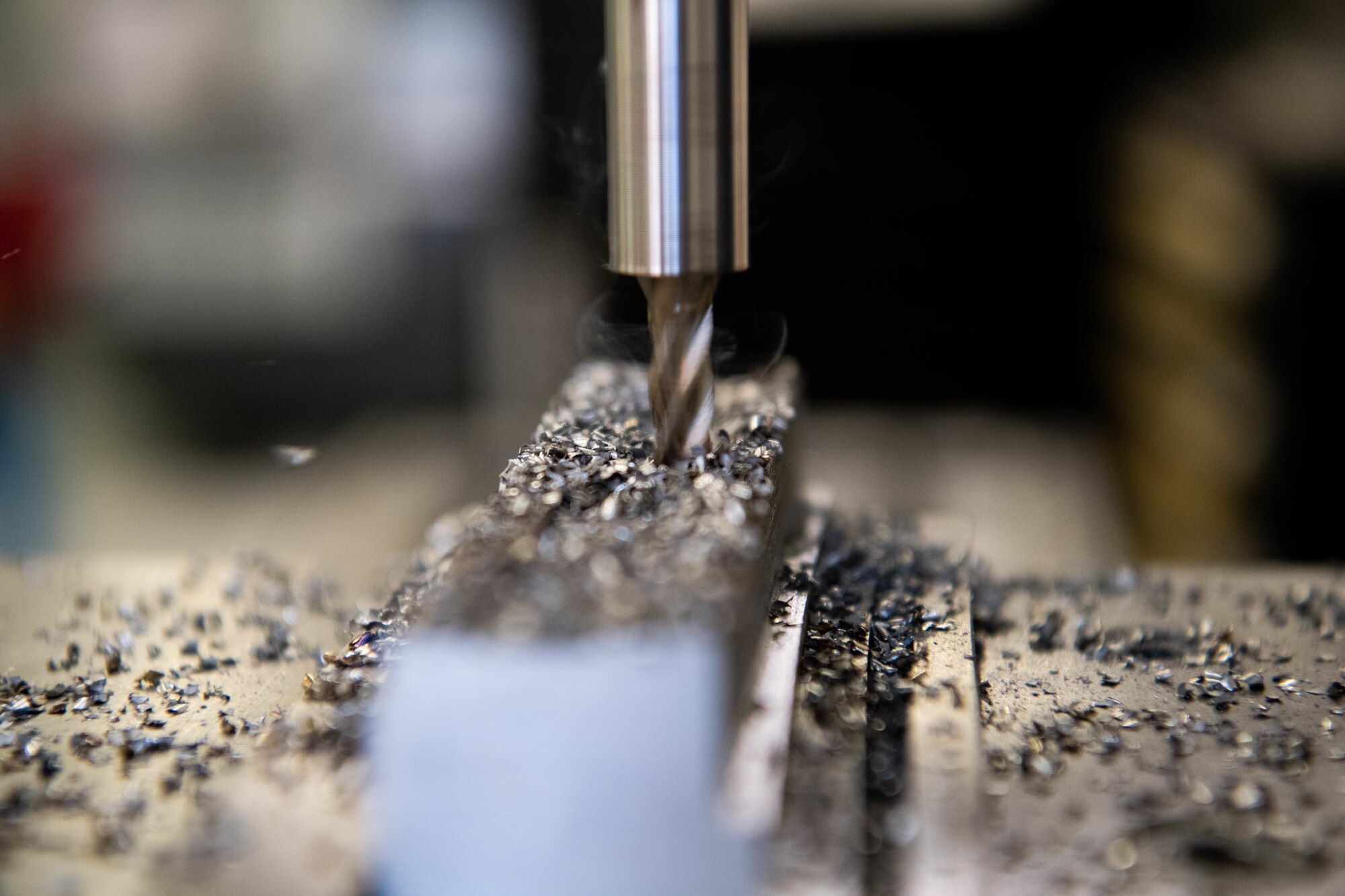 Staff Sgt. Branagan Glennen, 31st Maintenance Squadron metals technician craftsman, cuts a piece of metal using a mill  at Aviano Air Base, Italy, July 6, 2022. The mill is often used to fabricate aircraft parts and locally manufacture tools for different squadrons on Aviano. (U.S. Air Force photo by Senior Airman Noah Sudolcan)