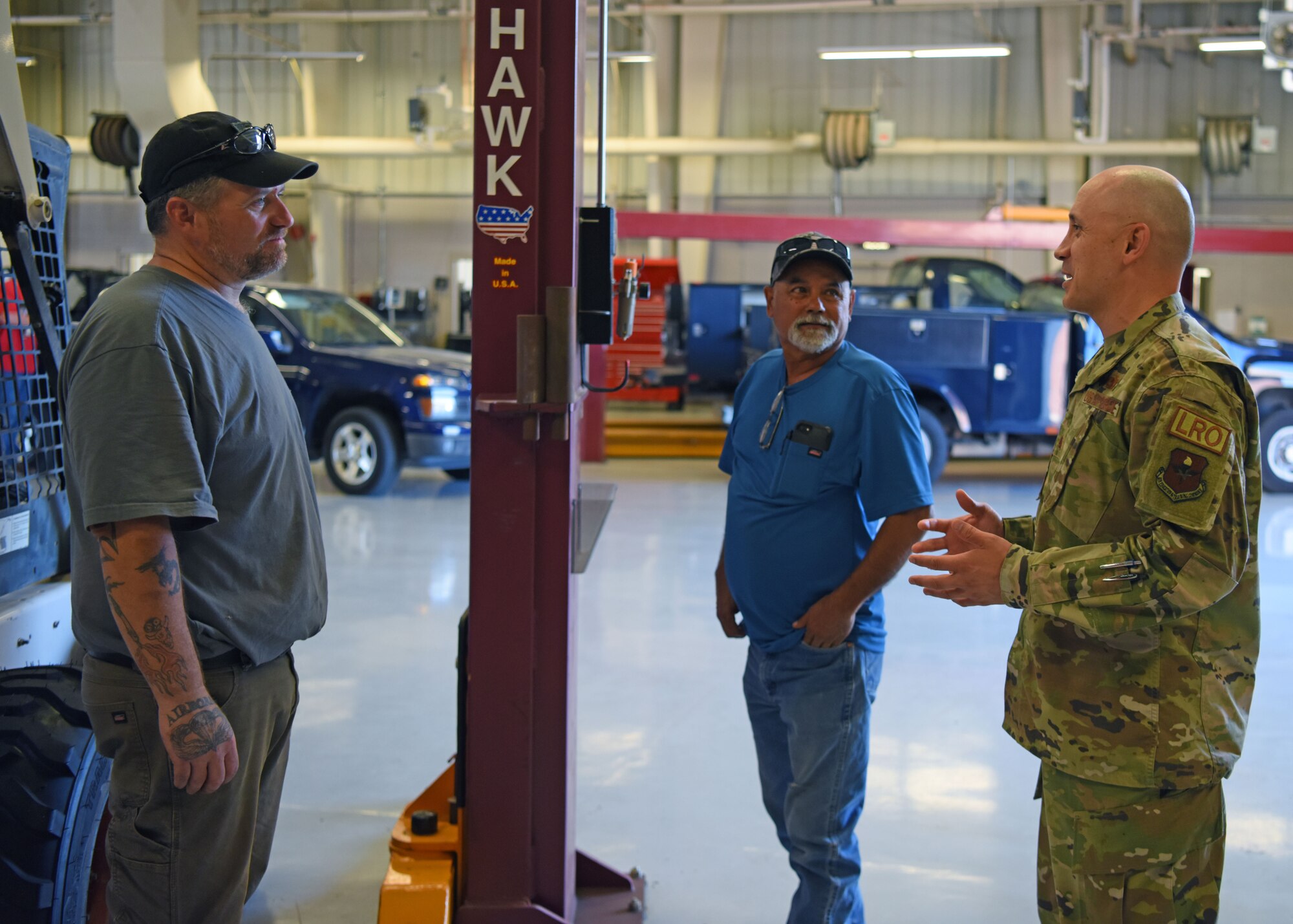 U.S. Air Force Maj. Jose Quintanilla, 17th Logistics Readiness Squadron commander, interacts with members of his squadron at the 17th LRS vehicle bay at Goodfellow Air Force Base, Texas, June 22, 2022. Quintanilla values a servant leadership approach and practices it within his squadron. (U.S. Air Force photo by Senior Airman Ethan Sherwood)